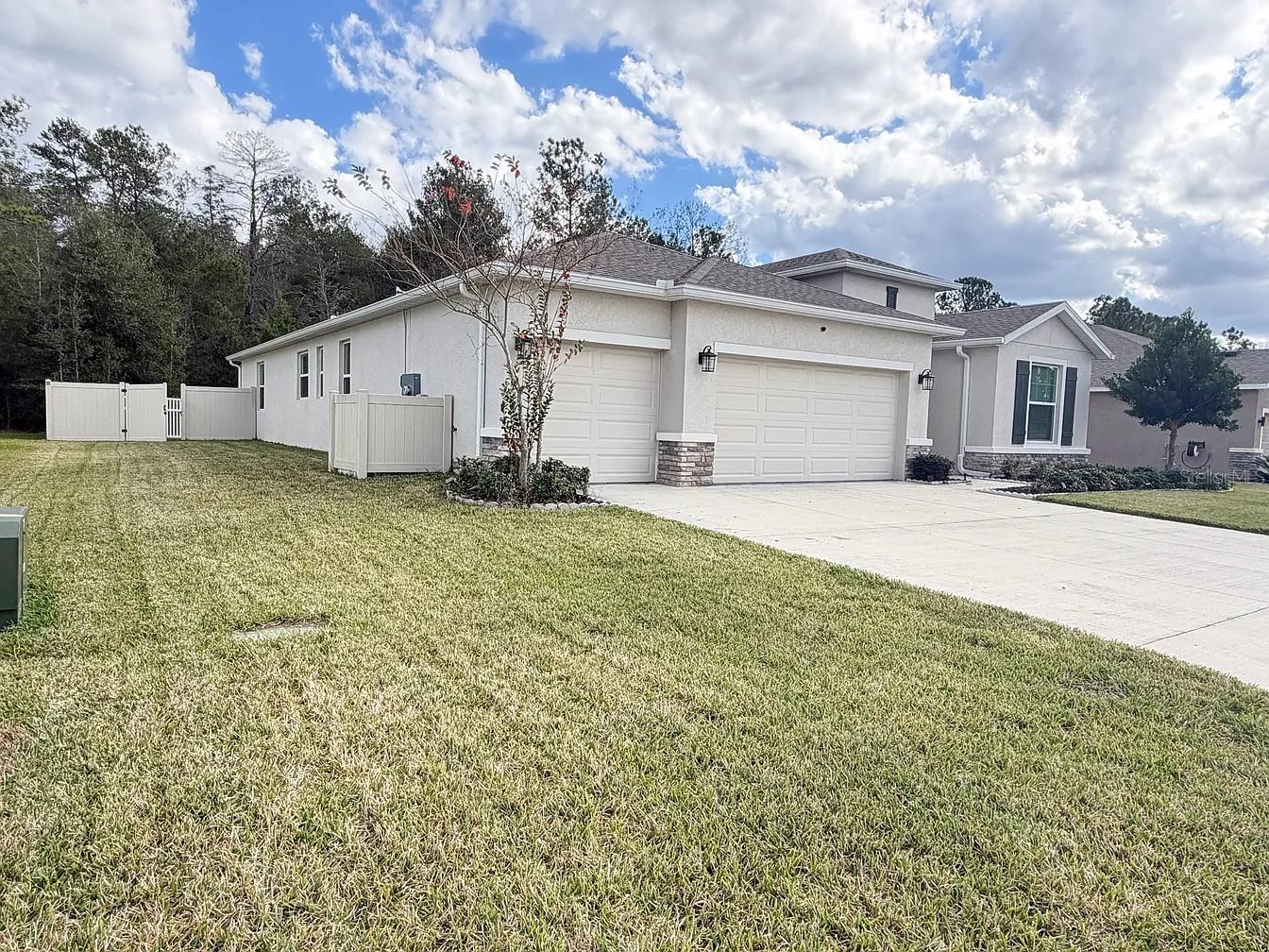This exceptional 4-bedroom, 3-bathroom residence features numerous high-end upgrades and sits on a premium lot with no rear neighbors, offering a rare sense of seclusion and tranquility. Step inside to discover a bright, spacious floor plan where attention to detail is evident throughout.
The expansive owner's suite provides a private retreat, complemented by an additional en-suite bedroom — ideal for guests or multigenerational living. Two additional well-appointed bedrooms share a convenient Jack-and-Jill bathroom.
Designed for comfortable daily living and effortless entertaining, the home offers abundant storage and thoughtfully designed living spaces. Enjoy year-round outdoor living from the screened patio, which seamlessly extends to the fully fenced backyard. The outdoor space features a large paved entertaining area complete with a built-in BBQ grill and sink — perfect for outdoor dining, gatherings, and relaxation. With no rear neighbors, you'll enjoy peaceful, protected views, enhanced privacy, and plenty of room for pets, play, and outdoor enjoyment. (Hot tub not included).
Ideally located with easy access to shopping, dining, medical facilities, and major roadways, this home combines the convenience of Ocala living with the prestige and privacy of an estate-style setting. Lawn maintenance included!