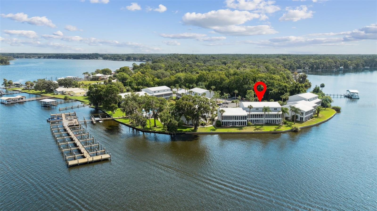 Located directly on the magnificent St. Johns River, this lovely first floor move-in ready 2BR/2BA condo unit offers a refreshing and relaxing view from the spacious screened porch of some awesome sunsets in addition to all the fishing and water activities you could ever dream of. The home comes completely and tastefully furnished, right down to the dishes. Just bring your toothbrush and fishing pole and you're ready to live the life of luxury. The unit has tile flooring throughout. Both bedrooms include mirrored, sliding closet doors, with the master suite overlooking the screened porch and river. Unlike most units, this one includes a stacked washer/dryer. Community amenities include a sparkling, fenced, in-ground pool, boat ramp, boat slip, first come basis and dock. Off street unassigned parking is available in the adjacent parking lot. This is a perfect year-round home, vacation or VRBO.