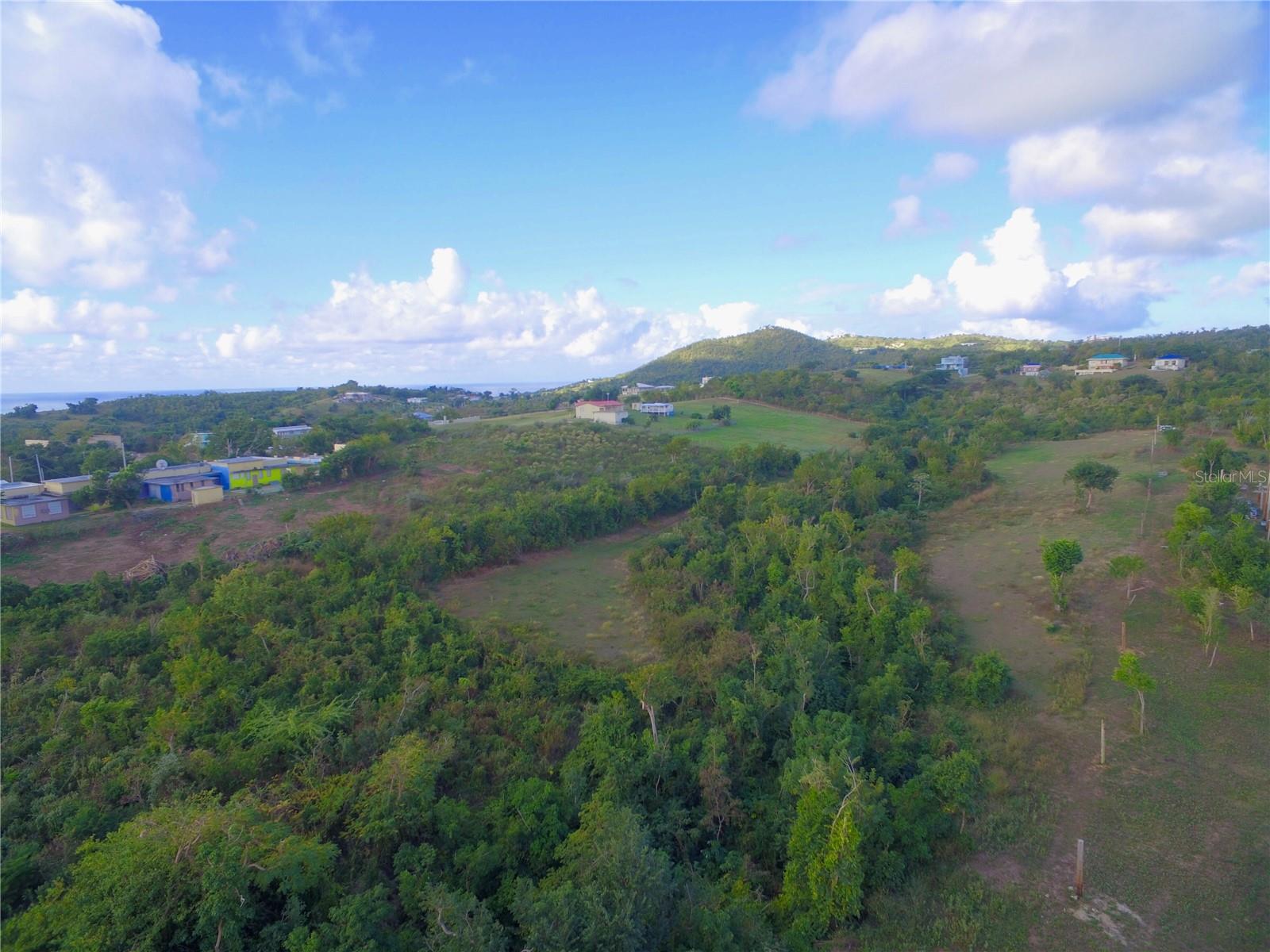 This expansive vacant parcel is located in the highly desirable Pilón–La Llave valley area of Vieques Island, Puerto Rico. Encompassing approximately 3.91 acres (approximately 4.03 cuerdas), the property offers a rare opportunity to acquire a sizable tract of land with east-facing views toward Barracuda Bay and the Vieques Bioluminescent Bay.

The property is situated in a peaceful, low-density setting known for its privacy, natural beauty, and established residential homes. Its orientation allows for consistent Caribbean trade winds and morning light, making it well suited for a custom residence designed to take advantage of views, airflow, and the surrounding landscape.

The parcel is largely undeveloped and features mature trees that provide natural shade and privacy. A seasonal creek runs east of the property, contributing to the area’s ecological character. The land offers ample space for a variety of residential design possibilities, including outdoor living areas, gardens, or additional amenities, subject to applicable permits and regulations.

Location is a key attribute of this property. It is approximately five minutes from Esperanza, including the Malecón, restaurants, and services, as well as Sun Bay Beach, Playa Negra, and Playa Grande. The Pilón and La Llave areas are among the most sought-after neighborhoods on Vieques due to their balance of seclusion and proximity to town and beaches.

The parcel is titled and is suitable for buyers considering off-grid or low-impact development, a common and practical approach on Vieques. Vieques Island is part of Puerto Rico, offering U.S. currency, established property rights, and ease of access, while maintaining a relaxed Caribbean lifestyle and natural environment.

This property presents an excellent opportunity for a private residence or long-term investment in one of Vieques’ most scenic and tranquil areas. Information regarding utilities, zoning, and development requirements is available upon request.