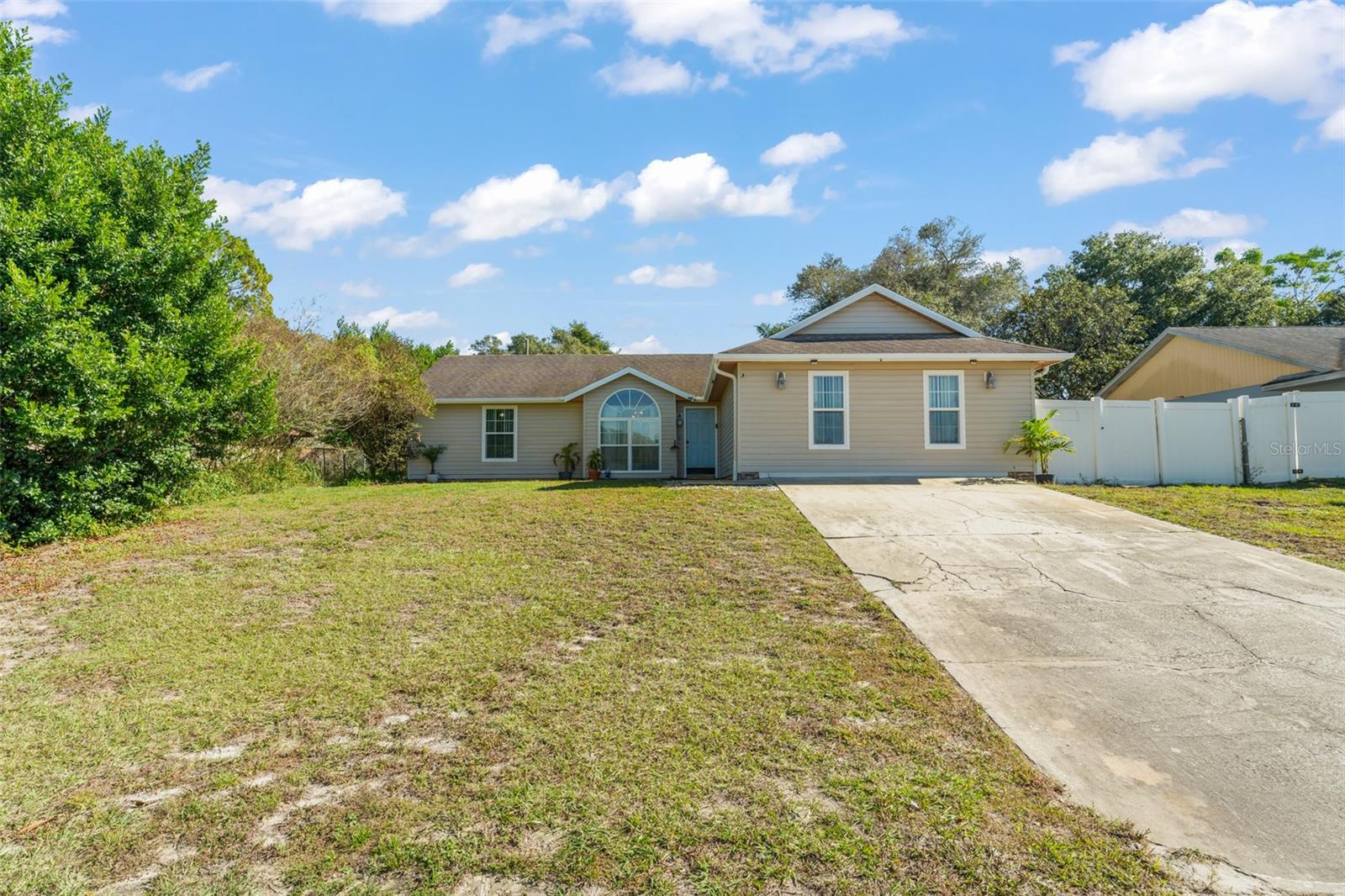 Discover the perfect blend of comfort, style, and Florida lifestyle in this beautifully maintained 4 bedroom, 2-bath POOL HOME, ideally situated on a spacious .23-ACRE LOT along a quiet street in a well-established neighborhood with NO HOA. Step inside to find a semi-open floor plan enhanced by tile flooring throughout the main living areas and primary bedroom, elegant crown molding accenting most of the home, and an abundance of natural light that creates a warm, welcoming atmosphere from room to room.

The kitchen is both functional and charming, showcasing crisp white cabinetry, stainless steel appliances, and a cozy breakfast nook framed by oversized windows overlooking the backyard, an ideal spot to enjoy morning coffee as sunlight fills the space. The thoughtful layout places the primary suite privately at the front of the home with convenient access to the laundry area, while a secondary bedroom is tucked at the back right, offering flexibility for guests or a home office. The third and fourth bedrooms are positioned on the left side of the home and share a well-appointed full guest bathroom, making the layout ideal for families or visitors.

Designed for effortless indoor-outdoor living, sliding glass doors from the dining area open to an enchanting covered patio that flows seamlessly to your PRIVATE BACKYARD OASIS.  Here, a large screened-in pool takes center stage, surrounded by mature landscaping that offers both privacy and shade, along with generous green space perfect for pets, play, or entertaining. Whether hosting weekend gatherings or unwinding after a long day, this backyard delivers year-round enjoyment in true Florida fashion.

Adding even greater value and peace of mind, the A/C was replaced in 2023 and includes a transferable 10-year warranty, and a NEW ROOF shall be INSTALLED prior to closing, giving the next owner confidence in the home's major systems for years to come. Ideally located in a peaceful suburban setting, this residence offers quick access to everything Central Florida has to offer, just minutes from nature preserves and scenic trails, approximately 30 minutes to Daytona Beach, about 30 miles to Orlando, and less than an hour to Florida's world-renowned attractions. Homes offering this combination of updates, outdoor living, and location are rare, schedule your private showing today!  **This house comes with a REDUCED RATE through the seller's preferred lender. This is a lender-paid rate buydown that reduces the buyer's interest rate and monthly payment.**