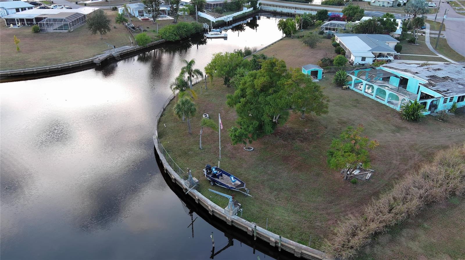 Discover an exceptional opportunity to build your dream home on this spacious 0.57-acre waterfront lot in a prime North Port location. Recently rezoned to AC-1 (Activity Center 1), the property is positioned within an area intended to support a mix of residential, commercial, and service-oriented uses, subject to city approvals, development standards, and site plan review. The property includes an existing uninhabitable structure, giving you a fresh start to design and build a home that fits your vision. With approximately 200 feet of seawall, the lot overlooks a peaceful canal connected to the Big Slough Canal and the Myakka River.  Ideal for kayaking, canoeing, and enjoying the natural surroundings. Mature fruit trees enhance the setting, adding both charm and character to the property. Two boat davit cranes are also on-site and may offer additional value with repair or replacement. Conveniently located near parks, golf courses, shopping, dining, and the well-known Warm Mineral Springs Park, this property offers a balance of privacy and accessibility. Gulf beaches are also within a reasonable driving distance for weekend escapes. With its oversized footprint, waterfront setting, and location in one of North Port’s growing areas, this is a rare opportunity to create something truly special. All information is deemed reliable but not guaranteed; buyers and buyer’s agents should verify all details.