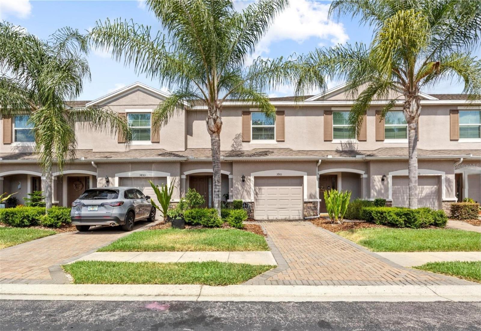 Imagine living in a lovely 3-bedroom, 2.5-bath residence in the gated Lakeside Townhomes subdivision located within the highly sought-after, Seven Oaks community. This move-in ready gem boasts an array of stylish features that truly set it apart. From the moment you walk through the door, you're welcomed by a cozy foyer leading into an open-concept layout perfect for both everyday living and entertaining. The family and dining areas flow seamlessly into a stylish kitchen featuring granite counter tops, stainless steel appliances, tiled backsplash, and walk-in pantry. Downstairs showcases crown molding, easy-care ceramic tile floors, while the staircase and second level of the home is dressed in luxury vinyl plank flooring throughout. The private screened-in patio offers a serene spot to enjoy your morning coffee or unwind after a long day. Upstairs, you’ll find 3 bedrooms, 2 full baths, and a convenient laundry closet. One of the 3 bedrooms is a spacious primary suite featuring a walk-in closet, an ensuite bath with dual sinks, and a large tiled shower stall. Enjoy access to Seven Oaks’ resort-style amenities, where you can host gatherings in the clubhouse and stream movies in the theatre room that holds 30 guests, snack at the on-site café, utilize the fitness center, Olympic and resort-style pools, splash pad for the tiny tots, tennis, basketball and volleyball courts, baseball/soccer field,  playground, and more. With quick access to I-75, and just minutes from Wiregrass Mall, Tampa Premium Outlets, Center Ice, The Grove, PopStroke, top-rated schools, and medical facilities such as Advent Health and BayCare Hospitals. This location simply can't be beat. Don’t miss your chance to own this stylish townhome in one of Wesley Chapel’s most desirable communities. Schedule your private showing today!