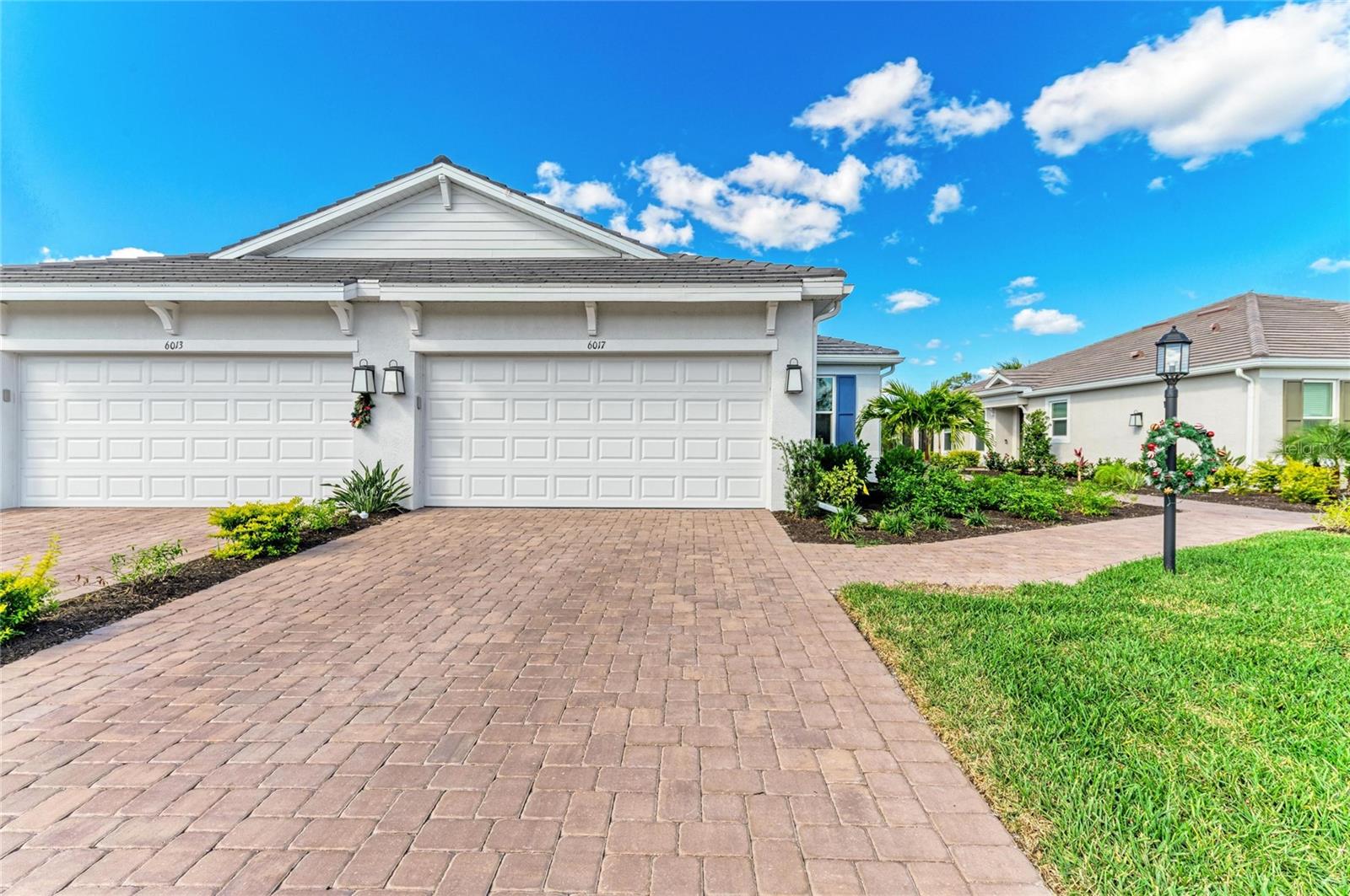 Built in 2025 and among the newest twin villas currently offered in Esplanade at The Heights, this exceptional Taylor Morrison Ibis floor plan distinguishes itself with its highly sought-after Coastal Elevation, premium private waterfront homesite, expansive backyard, and like-new condition. Perfectly positioned on a quiet dead-end street within this gated, maintenance-free community, this residence presents a unique opportunity to own one of the few recently completed twin villas featuring modern coastal architecture, a sleek flat tile roof, rare water-access homesite, and serene, uninterrupted water views. Combining luxury coastal living, maintenance-free convenience, and an exceptional location, residents enjoy easy access to Sarasota's renowned Gulf beaches, UTC shopping and dining, downtown Sarasota and Bradenton, top-rated schools, and I-75, while enjoying resort-style amenities and NO CDD fees. Showcasing the sought-after Ibis floor plan by Taylor Morrison, this thoughtfully designed residence offers 2 bedrooms, 2 bathrooms, and a flexible den/study that easily functions as a third bedroom—ideal for guests, a home office, or additional living space. Inside, natural light fills the open-concept layout, enhanced by IMPACT-RESISTANT windows and sliding glass doors for added energy efficiency, storm protection, safety, and comfort. The spacious Gathering Room features a tray ceiling with recessed lighting and pocketing sliding glass doors that seamlessly open to the screened lanai, creating an effortless indoor-outdoor lifestyle and the perfect setting to enjoy peaceful waterfront sunsets. The chef-inspired kitchen is both stylish and functional, showcasing natural gas cooking, quartz countertops, a stainless farmhouse sink, upgraded 42-inch cabinetry, a spacious closet pantry, and elegant pendant lighting over the breakfast bar. Adjacent to the kitchen, the dining area features a tray ceiling and provides an inviting space for everyday dining and entertaining guests. The private primary suite serves as a relaxing retreat with tranquil water views, a tray ceiling, newer laminate flooring, and a spa-inspired en-suite bath featuring a frameless glass walk-in shower, grab bars, and a generous walk-in closet. The guest suite also offers newer laminate flooring, a walk-in closet, and convenient access to its own en-suite bathroom. Nearby, the versatile den is enhanced with pocket doors, a tray ceiling, and recessed lighting, providing flexibility for work, hobbies, or overnight visitors. Additional upgrades and features include a customized laundry room with newer washer and dryer and pre-plumbing for a utility sink, 8-foot interior doors throughout, no carpeting, smart home technology, and a two-car garage featuring epoxy flooring and a reinforced storm-rated garage door. For added peace of mind, the transferable builder warranty and mechanical coverage remain in place. Residents of Esplanade at The Heights enjoy a resort-style lifestyle with a full-service clubhouse, spa, fitness center, lifestyle director, heated pool, tennis, pickleball, bocce courts, walking trails, and a Bark Park with exercise stations. Ideally located near UTC, downtown Sarasota and Bradenton, premier shopping, dining, top-rated schools, and world-renowned Gulf beaches, this remarkable residence offers the perfect blend of luxury, location, lifestyle, and value.