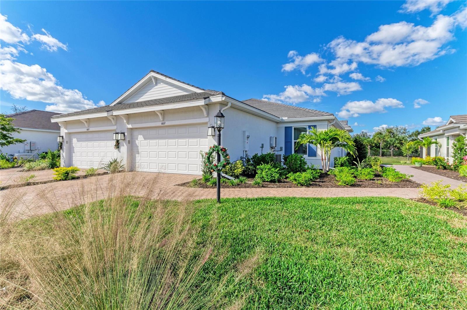 Motivated Seller – Bring All Offers! Built in 2025 and among the newest twin villas currently offered in Esplanade at The Heights, this exceptional Taylor Morrison Ibis floor plan distinguishes itself with its highly sought-after Coastal Elevation, premium private waterfront homesite, expansive backyard, and like-new condition. Perfectly positioned on a quiet dead-end street within this gated, maintenance-free community, this residence presents a unique opportunity to own one of the few recently completed twin villas featuring modern coastal architecture, a sleek flat tile roof, rare water-access homesite, and serene, uninterrupted water views. Combining luxury coastal living, maintenance-free convenience, and an exceptional location, residents enjoy easy access to Sarasota's renowned Gulf beaches, UTC shopping and dining, downtown Sarasota and Bradenton, top-rated schools, and I-75, while enjoying resort-style amenities and NO CDD fees. Showcasing the sought-after Ibis floor plan by Taylor Morrison, this thoughtfully designed residence offers 2 bedrooms, 2 bathrooms, and a flexible den/study that easily functions as a third bedroom—ideal for guests, a home office, or additional living space. Inside, natural light fills the open-concept layout, enhanced by IMPACT-RESISTANT windows and sliding glass doors for added energy efficiency, storm protection, safety, and comfort. The spacious Gathering Room features a tray ceiling with recessed lighting and pocketing sliding glass doors that seamlessly open to the screened lanai, creating an effortless indoor-outdoor lifestyle and the perfect setting to enjoy peaceful waterfront sunsets. The chef-inspired kitchen is both stylish and functional, showcasing natural gas cooking, quartz countertops, a stainless farmhouse sink, upgraded 42-inch cabinetry, a spacious closet pantry, and elegant pendant lighting over the breakfast bar. Adjacent to the kitchen, the dining area features a tray ceiling and provides an inviting space for everyday dining and entertaining guests. The private primary suite serves as a relaxing retreat with tranquil water views, a tray ceiling, newer laminate flooring, and a spa-inspired en-suite bath featuring a frameless glass walk-in shower, grab bars, and a generous walk-in closet. The guest suite also offers newer laminate flooring, a walk-in closet, and convenient access to its own en-suite bathroom. Nearby, the versatile den is enhanced with pocket doors, a tray ceiling, and recessed lighting, providing flexibility for work, hobbies, or overnight visitors. Additional upgrades and features include a customized laundry room with newer washer and dryer and pre-plumbing for a utility sink, 8-foot interior doors throughout, no carpeting, smart home technology, and a two-car garage featuring epoxy flooring and a reinforced storm-rated garage door. For added peace of mind, the transferable builder warranty and mechanical coverage remain in place. Residents of Esplanade at The Heights enjoy a resort-style lifestyle with a full-service clubhouse, spa, fitness center, lifestyle director, heated pool, tennis, pickleball, bocce courts, walking trails, and a Bark Park with exercise stations. Ideally located near UTC, downtown Sarasota and Bradenton, premier shopping, dining, top-rated schools, and world-renowned Gulf beaches, this remarkable residence offers the perfect blend of luxury, location, lifestyle, and value.