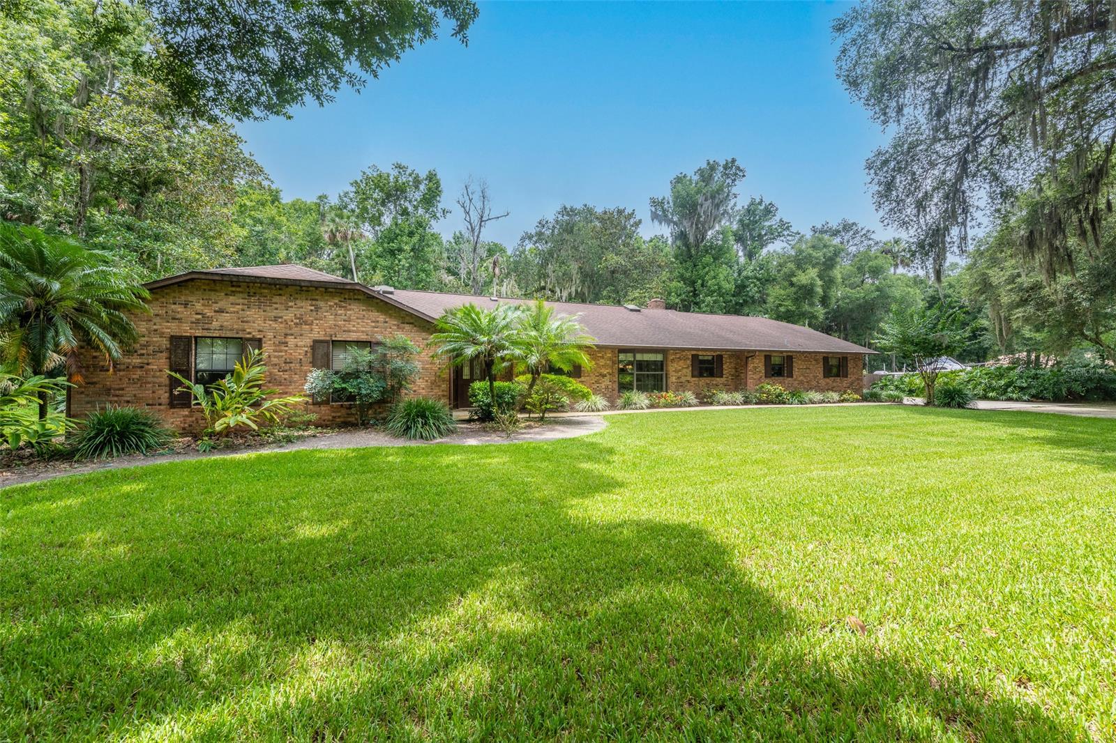 Extremely well-maintained home and property in a centralized New Smyrna Beach location.  This home is only 6 minutes from the beach and even closer to all that New Smyrna Beach has to offer! The property is surrounded by a lush mature landscape and there is also plenty of room for any size pool that you could imagine.  Inside you will find a beautifully maintained gem of a home.  There is a welcoming foyer that leads you to a very bright and comfortable living room that has a gorgeous view of the rear of the property. There is a wood burning fireplace in the large family room for those cool winter evenings and you can access the massive rear screened porch that overlooks the backyard so you can take in all of the wildlife that travels through the property. The dining room can handle larger gatherings and has easy access to the kitchen. The bedrooms are a good size and can accommodate a growing family. There is an oversized two-car garage attached to the home as well as an additional detached garage that can be used as a workshop or for additional storage. This well-maintained home is ready for you to make it your own. If you are looking for privacy and lots of room this is the home for you. Come and take a look today before it's gone. ;Water: City