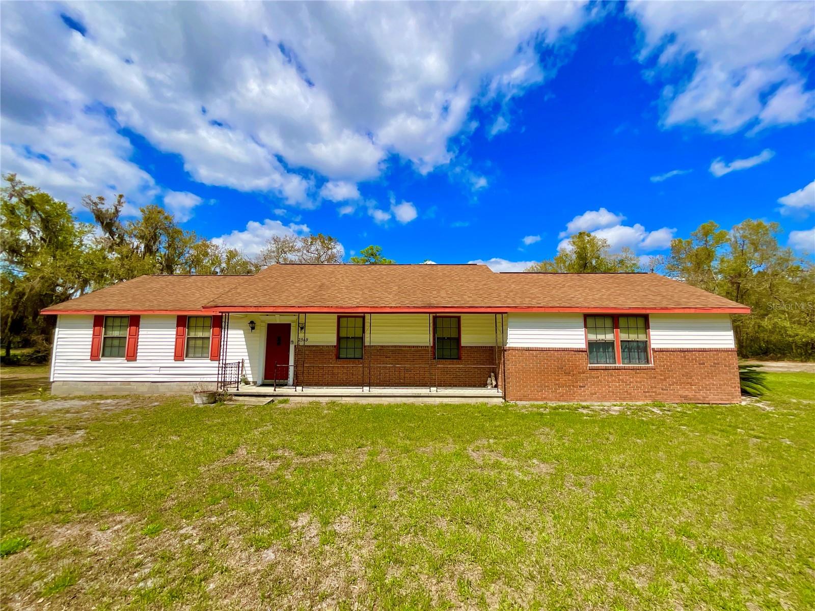 Tucked away in the peaceful Lake Santa Fe community in Keystone Heights, this inviting 3-bedroom, 2-bathroom home sits on nearly 1.5 acres of land, includes a 6000 Sq-ft Bradford County abandonment of 60Ft right-of-way in rear of property. Built in the early 1990s and thoughtfully maintained over the years, the home tells a story of care and reliability—from its consistently dependable well water system to its sand mound septic system with pump replaced in January 2020. The HVAC replaced in September 2013. Roof also redone in 2013, a newer hot water tank, Electrical Wiring in conduit throughout, visible in the attic and a Surge Blaster installed in the Meter by Clay Electric. The property expands beyond expectations, including additional usable land behind it, with a survey available and clearly marked boundary. A rear garage/shop addition completed in 2020 adds versatility for hobbies or storage, while the main house features warm wood kitchen cabinets and details like brick veneer over solid block construction. Surrounded by nature, the spacious lot offers room to grow and personalize.  Less than 10 minutes from Historic Melrose and 25 Minutes to Gainesville. Around the corner from the Boat Ramp to Lake Santa Fe’s 5800 acre, aquifer fed lake for fantastic fishing, water sports and more. Strong structural integrity, updated systems, and endless potential for customization, this home is more than just a place to live—it’s an opportunity to create your own paradise.