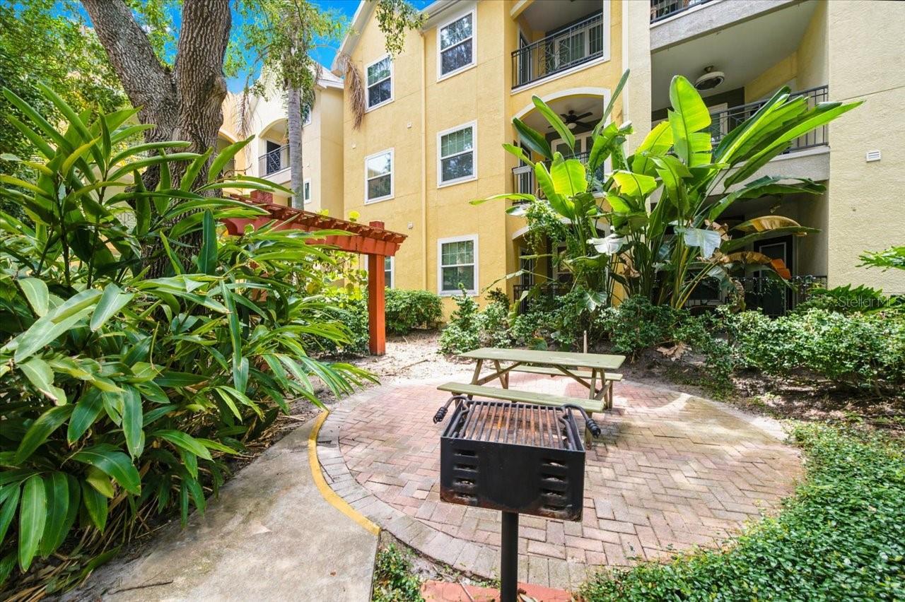 Experience refined urban living in this impeccably renovated residence at The Quarter at Ybor, one of Historic Ybor City’s most sought after condominium communities. This elegant second floor home offers 1 bedroom, 1 bath, a private office, and 867 sq ft of beautifully curated living space — all enhanced by the convenience of a dedicated, gated, covered parking space just steps from your door. A sophisticated interior renovation brings a fresh, modern aesthetic throughout. Enjoy brand new waterproof luxury vinyl plank flooring, a new A/C installed in 2025, and a fully repainted interior that feels crisp and contemporary. The spa inspired bathroom has been exquisitely redesigned with custom cabinetry, soft close doors, a stunning quartz vanity, and refined finishes that elevate everyday living. The bright and airy living room features built in shelving and flows seamlessly into a well-appointed kitchen with granite countertops, stainless steel appliances, a pantry, and generous cabinetry. A charming dining nook opens to your covered private balcony, offering a serene retreat for morning coffee or evening relaxation. The spacious primary suite boasts a large walk-in closet with custom built ins and direct access to the beautifully updated en suite bath with a garden tub and shower combination. An in-unit washer and dryer, along with a water heater replaced in 2019, add convenience to this luxurious space. Perfectly positioned in the heart of Historic Ybor, this residence offers effortless access to world class dining, boutique shopping, art galleries, nightlife, and the iconic Columbia Restaurant. A short stroll brings you to Centro Ybor and the trolley line connecting you to Downtown Tampa, Water Street, Riverwalk, and Sparkman Wharf. This is a rare opportunity to own a luxury, turnkey condo in one of Tampa’s most vibrant and historic districts. Indulge in elevated living — schedule your private showing today.
