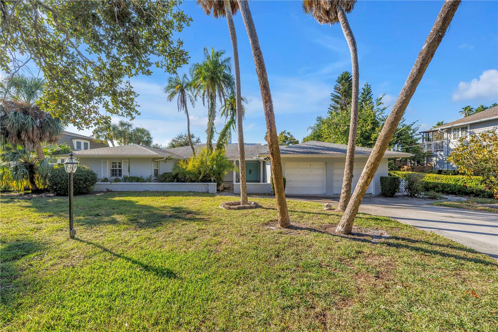 Welcome to one of the most coveted addresses in Harbor Bluffs—Harbor View Lane—where this rare and extraordinary waterfront property offers the ultimate in Florida coastal living. Perfectly positioned on a west-facing bluff, this 0.68-acre oversized lot (105’ wide x 290’ deep) captures breathtaking sunsets and features an unparalleled view straight down the channel to open water. The property’s elevated building pad sits high and dry, providing peace of mind and an ideal foundation for a future dream home in this prestigious neighborhood surrounded by multi-million-dollar estates.  The existing single-level concrete block home features spacious bedrooms, multiple living areas, and a raised pool and spa overlooking the sparkling waterfront. Whether you choose to remodel the current residence or build a custom estate, the sprawling backyard offers exceptional privacy and endless design possibilities.  Located just a short stroll from the Harbor Bluffs community park, this serene enclave combines quiet luxury with convenience—just minutes from the sugary sands of Indian Rocks and Belleair Beach, and close to Belleair’s charming town center, where boutique shopping and fine dining await.  This is a truly once-in-a-lifetime opportunity to own a prime waterfront lot on one of Harbor Bluffs’ most desirable streets—a setting that perfectly blends natural beauty, exclusivity, and coastal elegance.