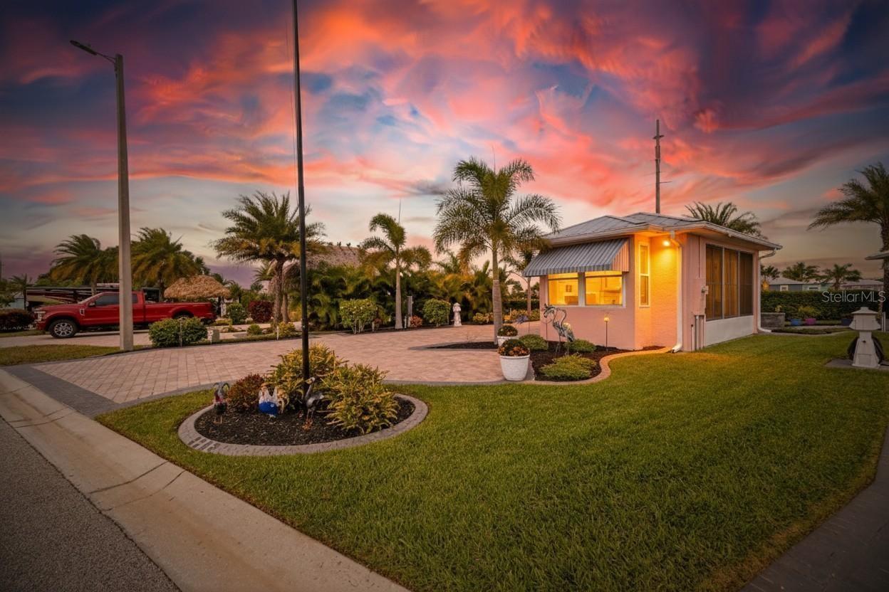 A large custom paver pad, professionally landscaped Lot. This huge enclosed pavilion is your personal paradise! Custom awnings, screened and glass windows in front and vinyl windows on sides make this the perfect entertainment area year round regardless of the weather.  Large TV,  Solid surface countertop, cabinets, sink and refrigerator convey. Large back patio with adjustable awning to relax in the sun or shade. Positioned next to a very large corner lot and casita this property can be purchased by itself or with the 2 BR/2 Bath next door as a package deal. Check out the adjacent property: 3287 Red Tail Hawk Dr. Bay Lake Motorcoach Resort is a Class A motorcoach resort offering incredible amenities. Owners and visitors can fill their days with activities and club outings or simply relax and enjoy the resort. Whether in search of community, travel, relaxation or recreation, Bay Lake is your home base for the Florida Lifestyle.