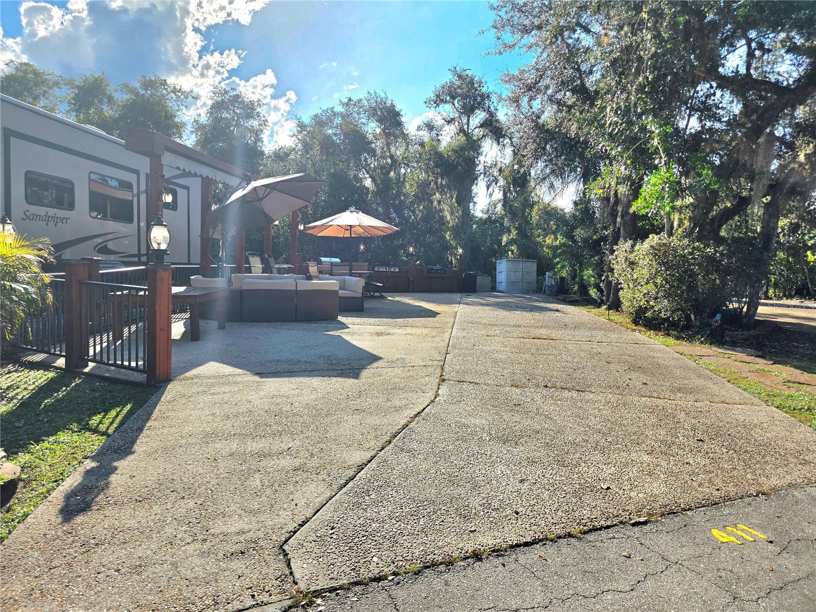Welcome to your own slice of paradise at the exclusive River Ranch RV Resort – one of Central Florida’s most sought-after luxury RV destinations. This turnkey RV lot, located in Phase 4, is just steps away from resort amenities including the pool, restrooms, showers, and laundry facilities – offering both convenience and comfort. Outdoor "Camping" at Its Best: This beautifully upgraded lot features a fully equipped outdoor kitchen, complete with a grill, and outdoor dining table – ideal for entertaining or unwinding under the stars. The lot is thoughtfully furnished with comfortable seating, plentiful outdoor furniture, and large umbrellas for shade, making it the perfect retreat year-round. Private Setting: Enjoy peaceful views with no rear neighbors, offering added privacy and a serene atmosphere surrounded by lush landscaping. Prime Location: Just around the corner, indulge in all the fun and excitement at Westgate River Ranch Resort, where you'll find on-site restaurants, adventure activities, a water park, and more (additional fees apply). As a River Ranch RV Resort owner, you’ll benefit from exclusive discounts at Westgate's dining venues and water park. Whether you're looking for a weekend escape, seasonal getaway, or income-generating investment,411 Longhorn Drive is your opportunity to own in a community where luxury meets outdoor lifestyle.