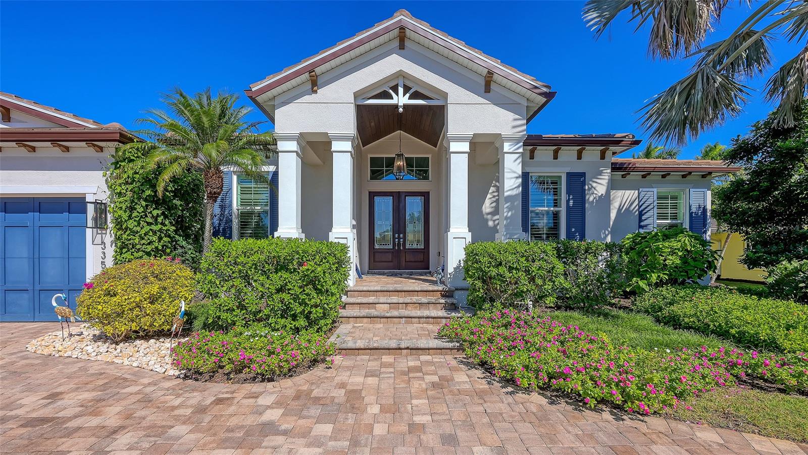 Experience the pinnacle of refined coastal living in this six-year-young custom Allegra masterpiece, perfectly situated in one of Sarasota’s most sought-after island communities. Designed with a seamless blend of architectural artistry and modern luxury, this residence is more than a home — it’s a statement of elegance, comfort, and lifestyle.
From the moment you arrive, the home’s presence is undeniable. 
A stately entryway leads you into a great room crowned by a soaring cathedral ceiling, where natural light cascades through expansive walls of glass. Every angle has been thoughtfully designed to frame the lush landscaping and expansive outdoor living spaces.  
The heart of this home is its open-concept design, where timeless finishes and compositional details creating a warm yet sophisticated atmosphere. The living and dining areas flow effortlessly into the gourmet kitchen, a chef’s dream featuring natural gas, stone counters, custom cabinetry, Wolf and Sub-Zero appliances, and an oversized island that invites both casual gatherings and culinary creativity. Whether hosting a grand dinner party or enjoying a quiet evening at home, this space adapts beautifully to every occasion. 
Beyond the main living areas, the home offers thoughtfully designed spaces to suit every need. A dedicated office provides privacy and focus for work or study, while a versatile den with corner pocket glass doors opens directly to the outdoor living area. This clever design creates a seamless indoor-outdoor flow, perfect for Sarasota’s year-round sunshine and breezes. The spa-inspired primary suite is a sanctuary of relaxation. Generously proportioned, it features serene views, a luxurious bath with dual vanities, a soaking tub, and a walk-in shower designed to rival the finest resorts. Spacious walk-in closets with custom built-ins complete the retreat, offering both elegance and practicality. The home has been thoughtfully designed with a split plan layout, offering exceptional privacy for both owners and guests.
Step outside to discover your private paradise. The outdoor living area is designed for both relaxation and entertaining, with a fully equipped summer kitchen, elegant wood-paneled ceilings, and multiple lounging and dining spaces. This retreat offers the perfect backdrop for poolside afternoons, al fresco dinners, or quiet evenings under the stars. Heated and cooled lap pool, spa, exterior Mosquito towers, garage built ins and a whole house Generac system complete the comforts of everyday living. Living here means more than just enjoying a beautiful home — it’s about embracing the Sarasota lifestyle in an Allegra Homes, known for their superior craftmanship, attention to detail and quality finishes at an unbeatable Bird Key address. With pristine beaches, vibrant cultural attractions, world-class dining, and boutique shopping just minutes away, every day feels like a vacation. This residence offers the rare opportunity to enjoy the best of island living while remaining connected to the heart of Sarasota.