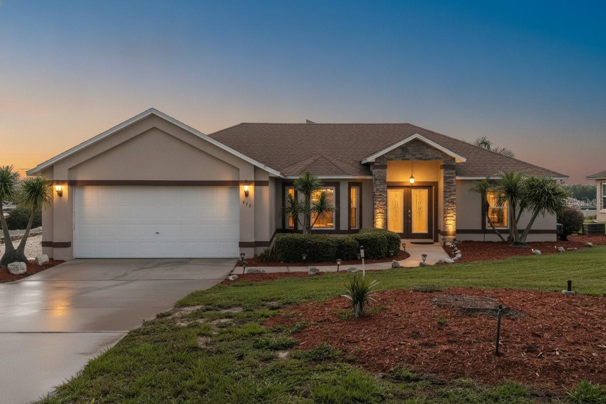 Virtually Staged. Perched on one of South Clermont's highest ridges in the gently rolling Hidden Hills community, this 3-bedroom, 2-bath Florida pool home delivers the kind of elevation, breeze, and view that buyers spend years searching for. From the moment you pull onto the oversized corner lot — bordered by open green space on one side and an added shale parking pad with room for a boat, trailer, or extra vehicles — you can feel that this property lives differently than the rest of the street.  Step inside to a light-filled, split-bedroom floor plan where freshly painted walls open into a recently updated kitchen featuring stone counters, a built-in bar, walk-in pantry, brand-new refrigerator, and a sunlit breakfast nook overlooking the backyard. A formal dining room, spacious living room, and dedicated inside laundry handle everyday life with ease. The owner's suite is tucked privately on the main floor with a walk-in closet and en-suite bath featuring dual sinks, a jetted garden tub, separate shower, and a brand-new toilet. Two guest bedrooms share a tastefully updated full bath. Energy-efficient replacement windows quietly trim utility bills month after month.  The real showstopper waits out back. A brick-paver pool deck wraps a sparkling gunite pool and in-ground spa with cascading water features, all framed by a screened enclosure that opens to an expansive, elevated water view. At sunset, the ridge breeze kicks in. At nightfall, Walt Disney World's fireworks light up the sky directly from your lounge chair — every single night.  Add a two-car attached garage with workshop space and dedicated boat parking, irrigation system, French doors to the lanai, covered and screened rear porches, and the rare luxury of no neighbor on one side, and you have a home that simply lives larger than its square footage. Public water and sewer, low $32/month HOA, designated Flood Zone X, zoned for Pine Ridge Elementary, Gray Middle, and South Lake High.  Homes with this elevation, this view, and this lineup of recent updates rarely come available in Hidden Hills. Schedule your private tour today.