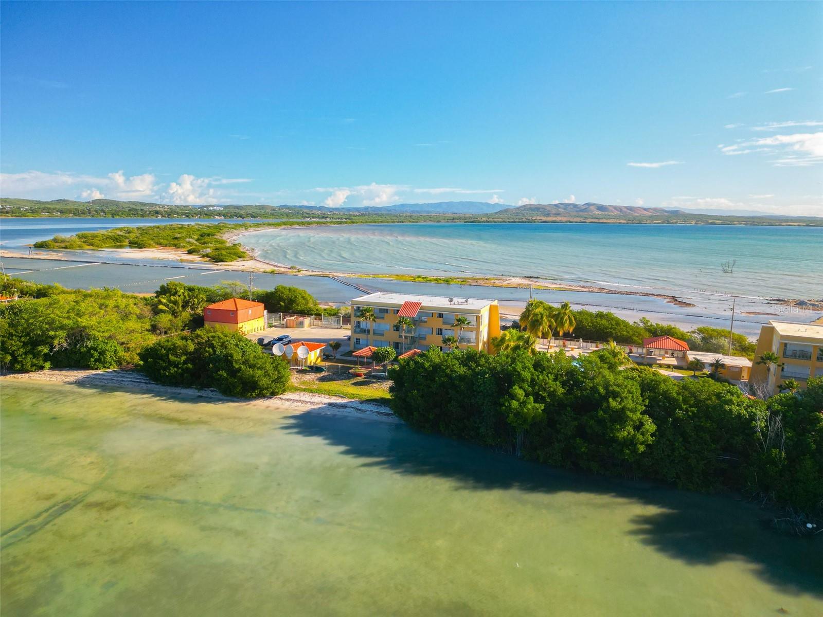 Two units in one — rare oceanfront income property at Playas del Caribe Resort, inside the Cabo Rojo National Reserve. This newly remodeled, fully furnished ground-floor unit has a flexible dual layout: a semi-hidden connecting door divides it into two independent spaces, each with its own bedroom, full bath, kitchen, and living area. Rent it as a 2-bed/2-bath, rent each side separately as two 1-bed/1-bath units, or live in one and rent the other — ideal for short-term rental income. Sold completely turnkey: all appliances, furniture, decor, linens, silverware, and both A/C units included. Move-in or rental-ready from day one. Enjoy direct bay access with an included double-seat kayak, a community pool, and on-site laundry. Minutes from downtown Cabo Rojo, the Cabo Rojo Lighthouse, the salt flats, hiking trails, and pristine beaches.