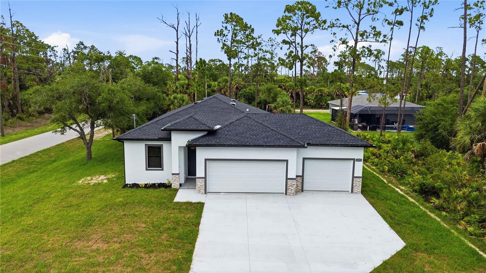 Virtually Staged. Why wait to build when you can enjoy the benefits of brand-new construction today? This beautifully built 2026 home in Port Charlotte combines contemporary style, thoughtful design, and quality finishes to create a space that's as functional as it is inviting.

Step inside to soaring 9'10" ceilings, luxury vinyl plank and tile flooring, and an open-concept layout filled with natural light. The spacious living and dining areas flow effortlessly into the heart of the home, a beautiful kitchen featuring quartz countertops, stainless steel appliances, soft-close cabinetry, and a large center island with breakfast bar seating. The style in this kitchen is undeniable with a modern backsplash, hood and even pulls that showcase the luxury you deserve. Whether you're hosting friends or enjoying a quiet evening at home, this layout was designed with everyday living in mind.

The private primary suite offers a peaceful retreat, complete with a walk-in closet and an en-suite bathroom featuring dual vanities and a spacious walk-in shower. Two additional bedrooms and a full guest bathroom provide flexibility for family, visitors, or a home office.

Slide open the triple-slider glass doors and enjoy your covered lanai, the perfect spot for morning coffee, weekend barbecues, or simply soaking in Southwest Florida's year-round sunshine. The generous backyard offers plenty of room to design the outdoor oasis you've always envisioned, whether that's a pool, garden, or outdoor kitchen.

Built for both beauty and peace of mind, this home also features hurricane impact windows, modern finishes throughout, and a spacious 3-car garage with room for vehicles, storage, or your favorite hobbies. There's even the perfect "mud room" with a built in bench. The attention to detail continues throughout.

Conveniently located near shopping, dining, parks, golf courses, boating, and Gulf Coast beaches, this home offers the ideal combination of comfort, style, and the Florida lifestyle in your dreams. Whether you're looking to enjoy a Rays or Braves game, the Wellen Park community, white sandy beaches of Englewood or Venice, this home is located near it all. 

Your brand-new beginning starts here—schedule your private showing today!