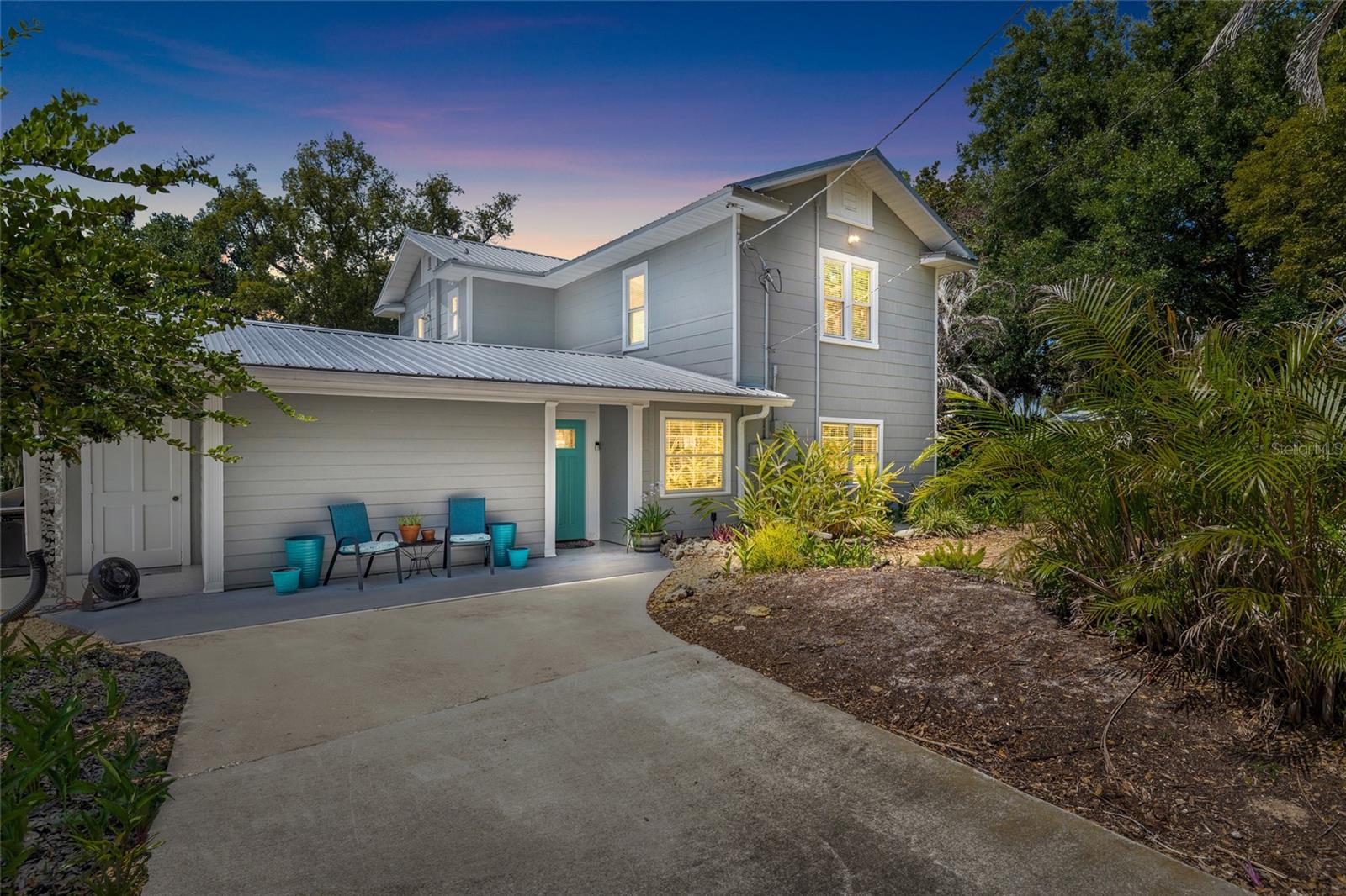 Welcome to this meticulously maintained historic home, originally built in 1925, where timeless character meets extensive modern updates. This one-of-a-kind property offers 3 large bedrooms, abundant storage, flexible living spaces, and an extraordinary detached garage/workshop that is rarely found in today's market.

Inside, you'll appreciate the charm of original hardwood floors in several rooms, spacious living areas, and tons of closet space throughout. The primary bedroom features two large closets, while the oversized pantry offers exceptional storage and conveniently houses the washer and dryer. The inviting family room is anchored by a beautiful fireplace, creating the perfect gathering space for family and friends. A charming 3-season Florida room provides additional living space and a relaxing spot to enjoy the outdoors year-round.

The home utilizes energy-efficient split HVAC systems for personalized comfort throughout the living areas, while the attached gym/flex room has its own separate heating and cooling system, making it ideal for a fitness studio, home office, workshop, or hobby space.

Major updates provide peace of mind, including all new appliances, a new metal roof, several brand-new windows, updated plumbing throughout, and new electrical wiring. The septic system was replaced in 2017, and the irrigation system operates from a private well.

Outside, the approximately 2,250-square-foot detached garage/workshop is truly a standout feature. Detached garage/workshop to be equipped, before closing, with its own dedicated electrical panel and updated lighting, providing a well-lit, functional space for a variety of uses.  This versatile space can accommodate a small boat, RV, tractor, multiple vehicles, equipment, or extensive workshop needs. Customizable movable interior walls allow the space to be configured to suit a variety of uses, while radiant barrier insulation helps keep the interior significantly cooler during Florida's warmer months.

For added value, the catamaran and gym equipment may convey with the home.

A rare opportunity to own a lovingly maintained historic home that combines timeless character, modern improvements, exceptional storage, flexible living spaces, and an incredible garage/workshop—all in one remarkable property.