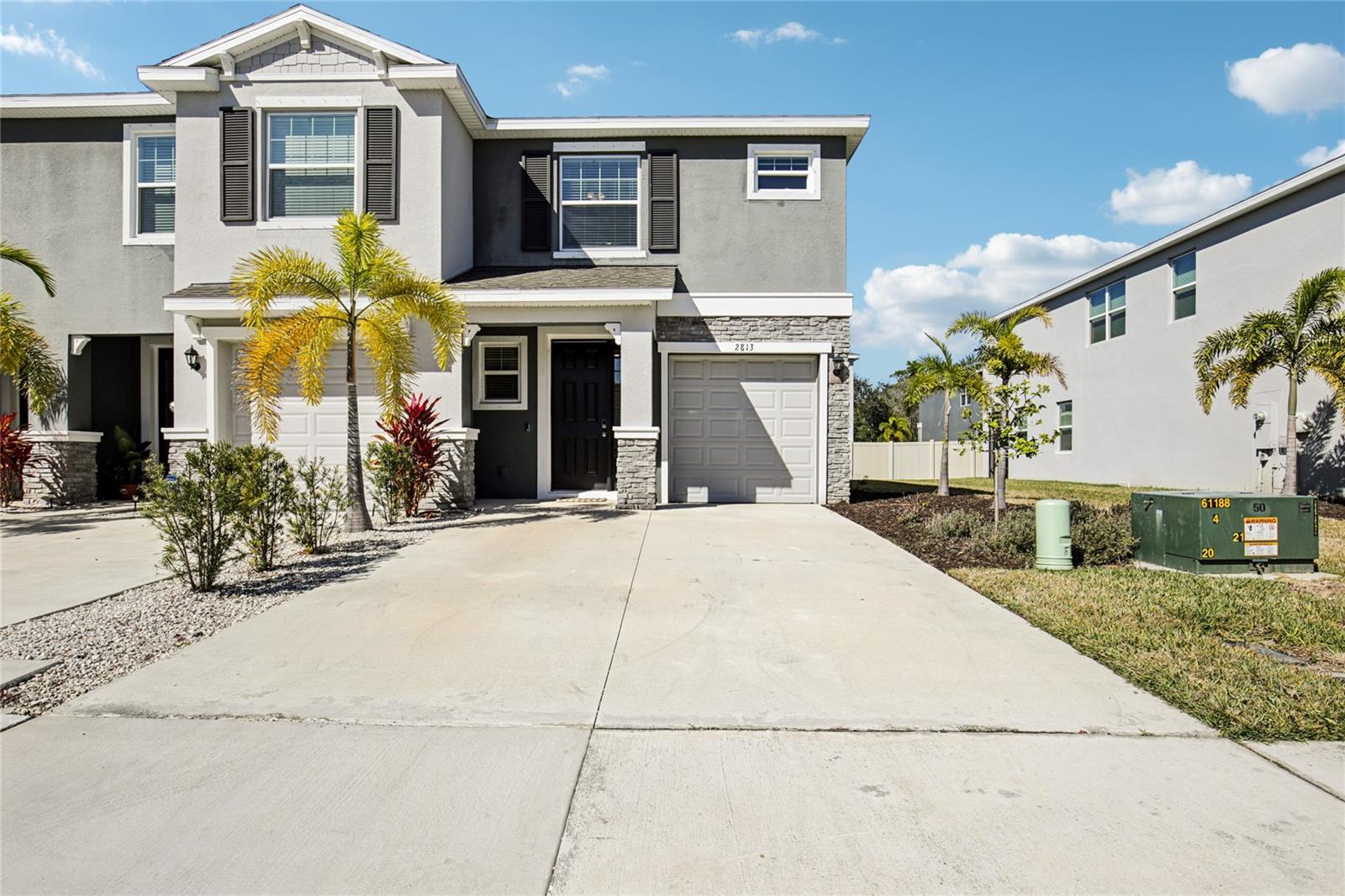 Price Improvement! Built in 2022, this end-unit townhome looks and feels brand new, offering a bright, open floor plan with tasteful improvements and beautiful light and bright Florida white cabinetry! Take peace of mind and receive insurance discounts with an insulated storm rated front door and heavy gauge metal shutters! Inside, the stylish kitchen features granite countertops, Stainless Steel appliances, subway tile backsplash, a walk-in pantry, and more! Sparkling large ceramic tile fill the first floor and upper floor bathroom spaces. Energy efficient insulation blown in to the newer Roof, newer Hot Water Heater and newer HVAC system have all been well maintained and keep your home comfortable. Low E, energy efficient double pane, tinted windows keep your home cool in the summer and warm in the winter. Upstairs, spacious separate bedrooms and a flexible loft provide room to relax, work and unwind. Enjoy added privacy with poured concrete block construction and a concrete party wall.  You'll appreciate everyday conveniences including a smart-home package, washer/dryer inside, one-car garage and two exterior parking spaces. The screen enclosed lanai open to the green belt is a wonderful private outdoor space to cookout, relax in the fresh air and enjoy Florida,  . Residents enjoy a gorgeous resort-style pool, fitness center, dog park, playground and more. Minutes from Waterside Place, Lakewood Ranch, UTC, Downtown Sarasota, and the world renowned beaches! No CDD fees and low HOA dues make this gorgeous home a standout value! Call today to schedule a private tour and see for yourself! Restrictions for lender contribution apply.