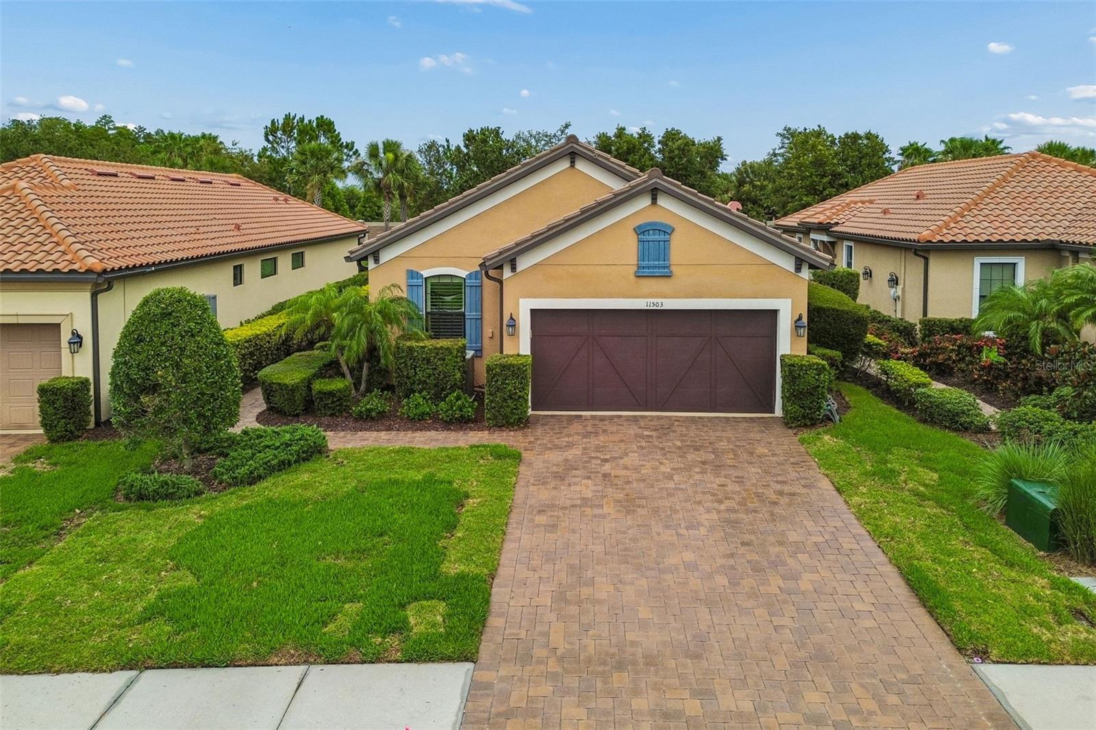 A POPULAR Taylor Morrison floor plan, the Arezzo, is ready for you in the gated community of Esplanade at Starkey Ranch. Well-known for its amenities and location, Esplanade has become a go-to for homebuyers looking for beauty, security, and tranquility. This stunning 3 bedroom, 2 bathroom, single-story residence showcases itself with a Mediterranean style exterior of stone, stucco, and corbel details. Paver driveway and walkway adds an upscale feel along with Florida native landscaping. Side entrance is captivating and private. Once inside, enjoy the open layout and tall ceilings/doors throughout. REAL wood flooring in main area, tile in prep areas and bathrooms. NO CARPET. The living area is cozy with a lot of natural light and picturesque windows and allows easy conversation to the designated dining area and kitchen. The kitchen provides a batwing island for additional seating, granite counter tops, 42in cabinets, custom backsplash, stainless steel appliances- GAS  RANGE, and large pantry. Dining room has crown molding/tray ceiling and can accommodate a large gathering. The primary retreat is separate and private and can easily fit a king sized bed. Beautiful windows and views of your outdoor oasis. Ensuite has dual sinks, granite counter tops, spacious walk-in tiled shower with glass enclosure and LARGE walk-in closet. Down the hall you find a flex space that can easily become a den, a fourth bedroom, an office or even a craft room- whatever your lifestyle needs! There is an upgraded bathroom with FULL tub/shower combo that provides an additional/separate entrance to the 2nd bedroom. The THIRD bedroom is tucked away towards the back of the home with added privacy. This room does provide a walk-in closet , 2 ceiling speakers, and stunning window views. Laundry room with added cabinets for more storage is right off of the 2 car garage with water softener, storage, and epoxy flooring. Tile roof. The POOL/SPA is screened in for you, is heated and is low-maintenance. Great size and perfect for the Florida life. Plenty of lanai space for lounging and entertaining and some covered space when you need a break from the sun. Mechanical systems serviced regularly. WATER SOFTENER. Callisia Dr. is a cul-de-sac street so there is minimal traffic. This home is located close to the clubhouse with kitchen and amenities which includes: heated salt-water pool, pickleball, tennis courts, fire pit area, park, dog park. In Starkey Ranch main, you also get to enjoy 3 additional pools, more parks and dog parks, Cunningham Lake, a public library, the Starkey K8 school, basketball courts, a track, tennis courts, a district park to include soccer/football/baseball fields, and MILES of walking/biking trails throughout the Starkey Ranch preserve. As an Esplanade resident, you get to enjoy maintenance free lawn care/landscaping! Grocery, medical, entertainment, restaurants, and shopping all nearby. Travel to both Tampa and Clearwater International airports are about 35 minutes away. This home has a lot, yet has room to make it your own. Click on video link for more!