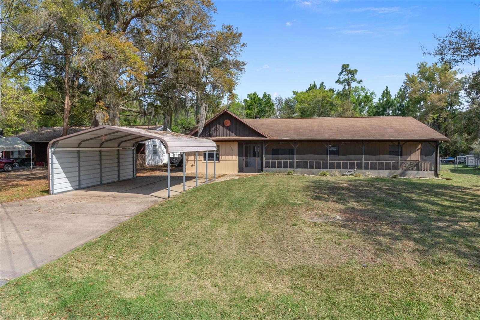 Welcome to this spacious and versatile 4 bedroom, 2 bath home offering 1,672 living square feet on a generously sized 0.25-acre lot in Crystal River. Featuring concrete block construction with attractive wood accent siding that adds character and curb appeal, this clean, vacant home is ready for immediate move-in. The flexible layout includes a thoughtfully converted garage serving as a 4th bedroom with a walk-in closet, along with covered carport parking for added convenience. Inside, you'll find a cozy fireplace and comfortable interiors designed for everyday living and entertaining. Enjoy screened porch areas at both the front and rear of the home, totaling approximately 643 sq ft and providing ample space to relax and enjoy the Florida lifestyle. The fenced yard, utility building, and patio add both function and outdoor appeal. With a natural backdrop of mature trees, the backyard offers a peaceful, more private setting that buyers will truly appreciate. This home presents a great opportunity for anyone seeking space, flexibility, and value, while still being conveniently located near local dining, shopping, and everyday essentials, as well as the springs, boating, fishing, kayaking, and other popular attractions that make Crystal River such a desirable place to call home. Easy access to US Highway 19 and the Suncoast Parkway adds even more convenience for travel throughout the Nature Coast and beyond.