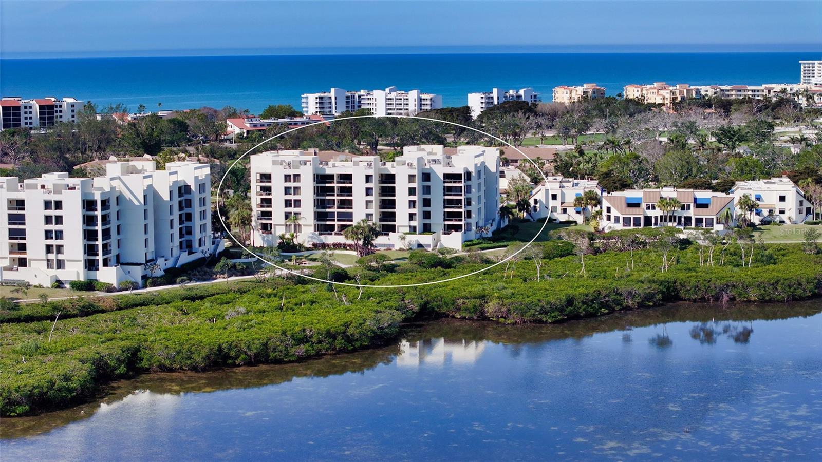 Welcome to this breathtaking, fully remodeled, turnkey furnished contemporary residence in Fairway Bay—nestled on picturesque Longboat Key. From the moment you enter, you're greeted by a thoughtfully redesigned open floor plan, elevated ceilings, solid core doors, and impeccable high-end finishes. IT IS TRULY ONE OF A KIND! This condominium is truly one-of-a-kind! Exceptional Kitchen features include: Bertazzoni induction range, refrigerator, and dishwasher, built-in Miele plumbed espresso machine, sleek, low-profile custom cabinetry with quartz countertops, glass tile backsplash and ambient lighting and an expansive quartz island perfect for formal dining or casual entertaining. The living room flows effortlessly from the kitchen, opening onto a covered, tiled lanai—blurring the line between indoor and outdoor living. Floor-to-ceiling impact windows frame panoramic views of Sarasota Bay, the Ringling Bridge, and the city skyline, offering million-dollar scenery from the comfort of your home. Enter the generously sized and luxurious Primary Suite with custom built-ins and ample closet space. The ensuite bath is a spa-inspired bath with dual vanities, Hansgrohe Axor faucets, Toto washlet, walk-in shower with multiple heads and elegant finishes. The guest suite features custom cabinetry and an ensuite bathroom with a Victoria & Albert volcanic limestone bathtub. Other recent upgrades include Hurricane-impact windows and doors, tankless water heater, additional upper cabinetry in kitchen and utility room, ceiling fans and more. For your convenience & comfort there is easy elevator access, coveted garage parking space and private onsite storage. Fairway Bay residents enjoy the resort-Style amenities including Deeded beach access & exclusive beach club, 24-hour gated security, pool, spa, tennis courts, and fitness center plus all the perks of Bay Isles living. Whether you're soaking in the sun, enjoying vibrant Sarasota culture and nightlife, or relaxing in your private retreat, this home is a perfect sanctuary.