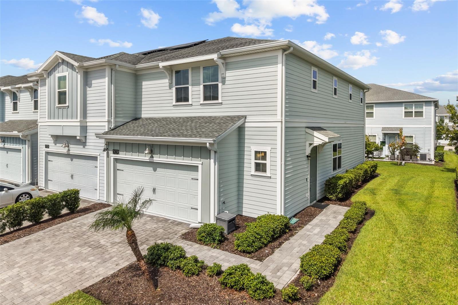 Welcome to effortless resort-style living in the highly sought-after gated community of Storey Lake Reflections. This beautifully maintained 3-bedroom, 2.5-bath end-unit townhome combines modern elegance, thoughtful design, and an exceptional location just minutes from Orlando's world-renowned attractions. Used only as a seasonal residence, this home has been meticulously cared for and offers the feel of a nearly new property. As an end unit, it enjoys an abundance of natural light and added privacy with extra windows and a spacious side yard rarely found in townhome living. The open-concept floor plan is designed to bring everyone together. At its center is a beautifully appointed kitchen featuring stainless steel appliances, a wine fridge, stone countertops, abundant cabinetry, and an oversized island with bar seating, perfect for casual dining, entertaining guests, or gathering with family. The kitchen seamlessly flows into the expansive living and dining areas, creating a bright and inviting atmosphere throughout. Upstairs, the spacious primary suite serves as a private retreat with a generous walk-in closet and a spa-inspired en-suite bathroom complete with dual vanities, a soaking tub, and a separate glass-enclosed shower. Two additional bedrooms, a full guest bathroom, and a conveniently located second-floor laundry room complete the upper level. Modern smart home technology enhances everyday living with a Ring video doorbell, smart thermostat, smart kitchen lighting, and a MyQ Wi-Fi garage door opener. The attached two-car garage offers excellent storage, while the patio and expansive side green space provide the perfect setting to relax outdoors or entertain. Living in Storey Lake means enjoying one of Central Florida's premier resort-style communities. Residents have access to an impressive collection of amenities including a lazy river, a resort pool, thrilling water slides, splash pad, fitness center, tiki bar and grille, kayak and canoe rentals, miniature golf, volleyball and basketball courts, playgrounds, dog park, scenic walking areas, and lakeside picnic spaces. HOA dues include cable, high-speed internet, and phone service for added convenience. Ideally positioned in the heart of Kissimmee, you'll be just minutes from Walt Disney World Resort, Disney Springs, Universal Orlando Resort, SeaWorld, The Loop shopping and dining district, championship golf courses, Orlando International Airport, and major highways, making commuting and exploring Central Florida effortless. Whether you're searching for a full-time residence, a seasonal getaway, or an exceptional investment opportunity, this move-in-ready home delivers the perfect balance of luxury, comfort, convenience, and the coveted Florida lifestyle.