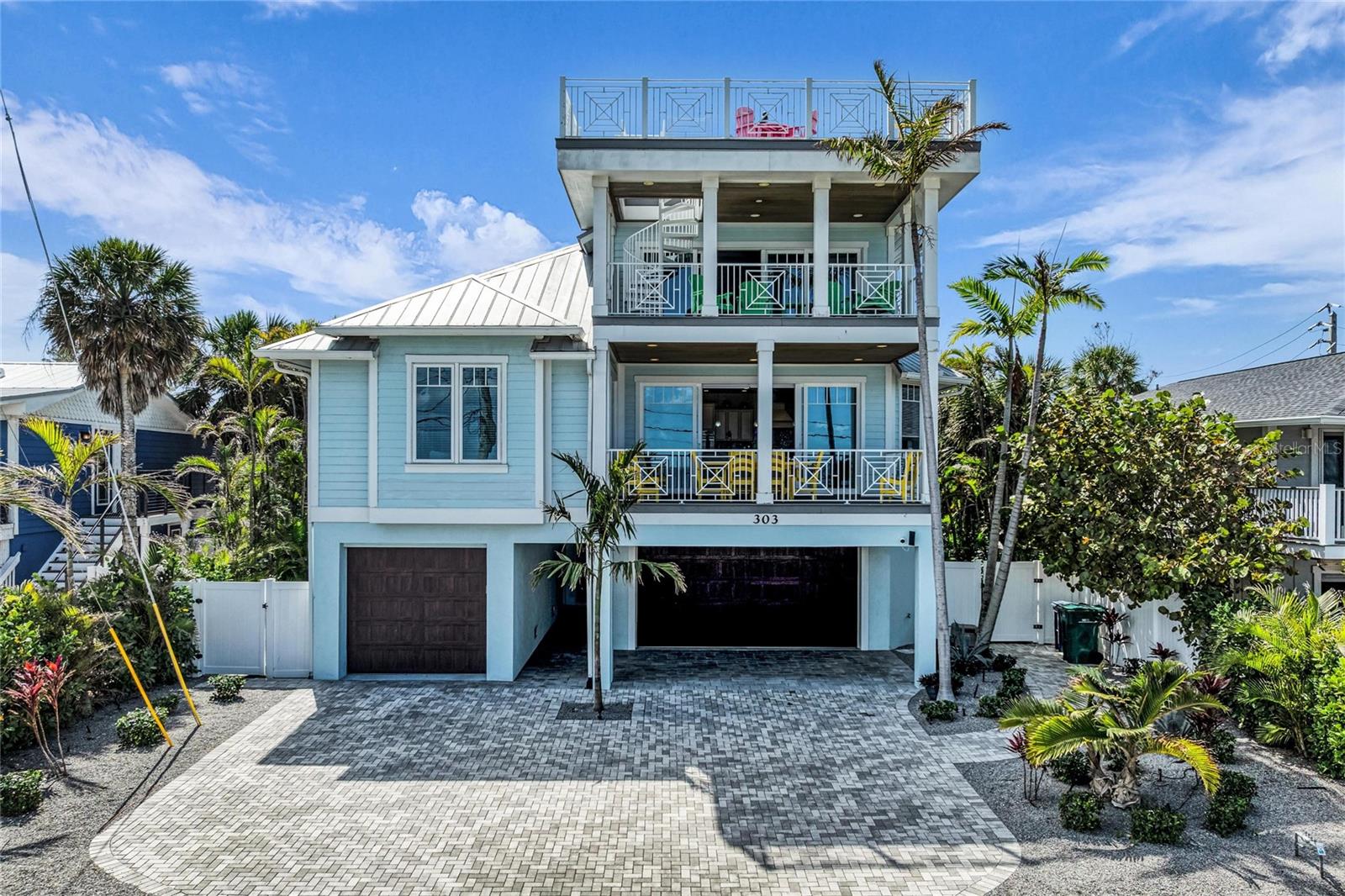 ~~~ MUST SEE FLY THROUGH VIDEO ATTACHED ~~~ Experience elevated island living in Anna Maria's Best; this custom three-level, five-bedroom, three-and-a-half-bath AND 5 DECKS!  This island home offers stunning views and exceptional indoor-outdoor living. Designed for both comfort and entertaining, the main living level features a spacious open-concept layout with a large living area, dining space for ten, and a gourmet kitchen highlighted by an impressive 10-foot island—perfect for gathering with family and friends. A large laundry room and convenient half bath are also located on this level.  Professionally designed with color, comfort and perfection in mind.  Just off the living room step outside to enjoy an expansive balcony a with full views of Tampa Bay and it's sparkling water.  If you need your own balcony, there are more!  Enjoy the cozy balcony overlooking the private pool, hot tub, and putting green, creating the ultimate outdoor retreat.  The primary suite is located on the second floor, offering privacy along with a spacious en-suite bath.  Wake up to the amazing view and step straight out to the balcony for breakfast and coffee.  There are two additional bedrooms to provide ample accommodations for family and guests.  Take a ride in the elevator, that starts in the garage and goes all the way to the top, up to the third level features two additional bedrooms, a full bath, and an inviting media room complete with an 80" TV, beverage cooler, and bar, making it the perfect space for relaxing or entertaining.  Open up the large sliders while you watch the game and the let the ocean breeze create the vibe.  With yet another large covered balcony for over flow or just chilling with a cocktail as you take in one of the MANY stunning sunsets of the year.  If the pool is your scene, Anna Maria's Best has a large pool, hot tub and tons of seating so you can catch some rays, read a book in the shade or take on the team in on the putt putt green.  When you return from the beach, you can rinse off in the fully enclosed outdoor shower.  At the top, a rooftop deck delivers breathtaking 360-degree views of the island and spectacular vistas of Tampa Bay, providing an unforgettable place to watch sunrises, sunsets, and everything in between.  Additional highlights include a 4+ car garage and a prime island location just minutes from shops, restaurants, piers, and a quick golf cart ride to the beautiful beaches of the Gulf of Mexico.  This exceptional home offers the perfect blend of luxury, views, and island convenience.  Come live your Anna Maria Life in Anna Maria's Best NOW!