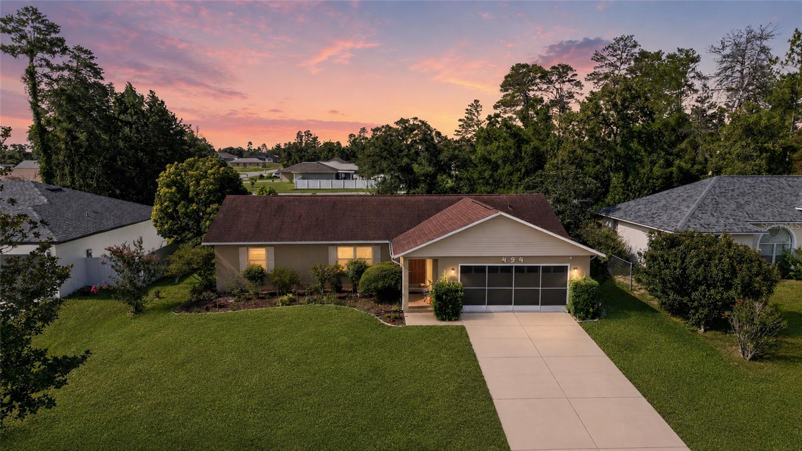 Marion Oaks – All Ages Community. NO HOA. NO HOMES BEHIND. Well-maintained 3/2 BLOCK HOME with a 2-CAR GARAGE, TILE FLOORING THROUGHOUT (NO CARPET), and a large screened LANAI/BIRDCAGE overlooking a FENCED YARD and peaceful garden oasis. ROOF 2019. HVAC 2018.

The foyer opens into a comfortable living room and flows into the dining area with an ARCHED ENTRY and CROWN MOLDING. The kitchen features STAINLESS STEEL APPLIANCES, a breakfast bar, cabinet pantry, and a dinette with backyard views. French doors off the dining room lead to the covered lanai and extended birdcage with TILE & CHATTAHOOCHEE FLOORING, offering a private view of the fenced yard with NO REAR NEIGHBORS.

The OVERSIZE PRIMARY BEDROOM provides extra space for a sitting area, along with a WALK-IN CLOSET and an en-suite that includes a PRIVATE TOILET ROOM, STEP-IN SHOWER WITH GRAB BARS, and a privacy window for natural light. The SPLIT Floorplan is convenient and the other two Bedrooms both have built-in closets. The guest bath has a TUB/SHOWER Combo and single vanity. 

The property is ideal for anyone who enjoys gardening or outdoor projects — mature landscaping, a GREENHOUSE WITH MISTER SYSTEM, two sheds, a relaxing pergola sitting area, and established plantings including Azaleas, June rose, Crape myrtle, Roses, Jasmine, Staghorn fern, Loquat, and Filipino lime (Calamansi).

The 2-CAR GARAGE includes slider screens, windows, and additional storage. A solid, easy-to-maintain home with strong INDOOR-OUTDOOR LIVING and NO REAR NEIGHBORS — a great option in Marion Oaks. Schedule your private showing today!