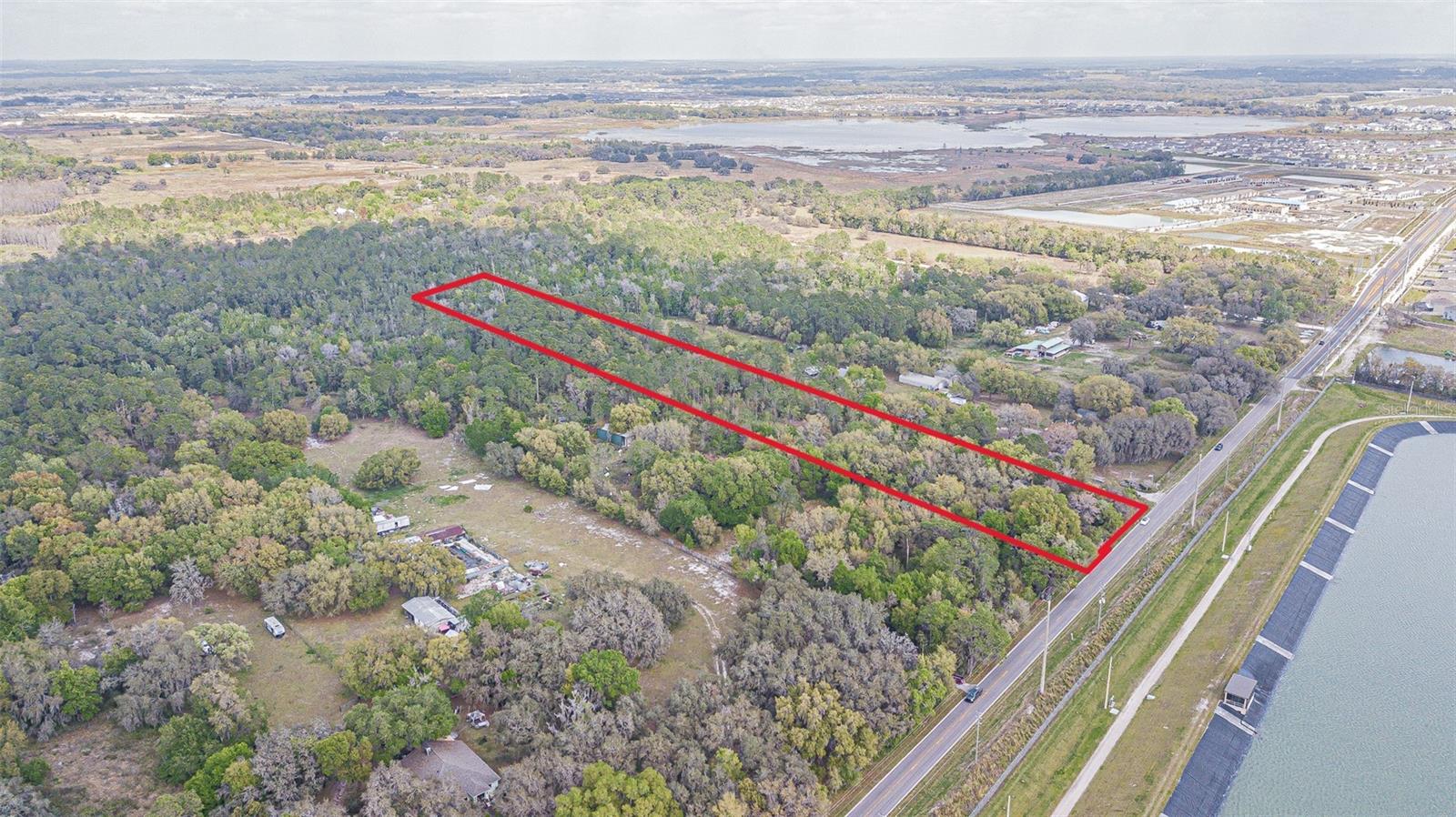 Opportunity to develop SFR or townhomes on 10-65 acres by combining with adjacent properties. Join with a potential 65 acres next door to get 750' on Elam Road and over 1,000' on Kenton Avenue, just a ½ mile away from the new, 56-bed Johns Hopkins All Children's hospital that broke ground and is expected to open in 2027.

Or existing AC zoning allows schools, solar farms, churches (religious facilities), and civic organization buildings. Special exception uses: cemeteries, golf courses, day-care centers, and private schools.

Nestled in the heart of the Community Hub Spa Zone in the thriving Connected City, this parcel is not just land; it's the gateway to your next success story. Seize the opportunity to redefine luxury living and urban convenience on this fantastic canvas. Imagine crafting a masterpiece that resonates with the pulse of progress – strategically rezone for higher density and watch as your vision springs to life. This prime location is a heartbeat away from the bustling Epperson Ranch, Mirada, and Watergrass developments, making it the epicenter of growth and vitality. King Lake, poised to evolve just a block away with a harmonious blend of homes and offices, sets the stage for a vibrant, interconnected community. Strategically positioned near the Interstate ramp at I-75, accessibility meets desirability, promising a seamless blend of urban convenience and suburban tranquility. 

The proximity to the county recreation center ensures your future residents will have their own haven of leisure and entertainment just moments away. Step into the embrace of nature with a conservation area adorned by majestic oak trees, providing the perfect backdrop for sustainable development and a touch of rustic charm. With large oaks dotting the landscape, the ambiance of the property is one of natural elegance, creating a serene haven for future residents. Approximately 5.28 acres of this sprawling 10-acre gem are ready to be transformed into a haven of townhome/mixed use excellence. Whether you envision a modern enclave or a charming community nestled within nature's embrace, the possibilities are as vast as the land itself. The potential for a seamless transition from vision to reality is unprecedented. However, let's not just talk about the acreage – let the figures speak for themselves. Buyers and buyers' agents, rest assured, as we provide transparent information. While approximately 5.28 acres are marked for development, the potential for density and the usable acreage is a matter that should be explored with the guidance of your own engineering firms. Your vision deserves nothing less than the most accurate and reliable information. Unleash your creativity, unlock the potential, and make your mark on Elam Road. This is more than just a piece of land; it's an investment in a future where innovation, nature, and community converge. Secure your piece of the Connected City today, and let the legacy of 30651 Elam Road begin! Buyers/Buyers Agents are not to rely upon any usable acreage or density estimates from listing agent or seller-utilize your own land consultant and/or engineer. *Address # not assigned yet. Join contiguous parcels next door for up to a 95 acre development opportunity.  Survey, wetland map and phase 1 reports completed.