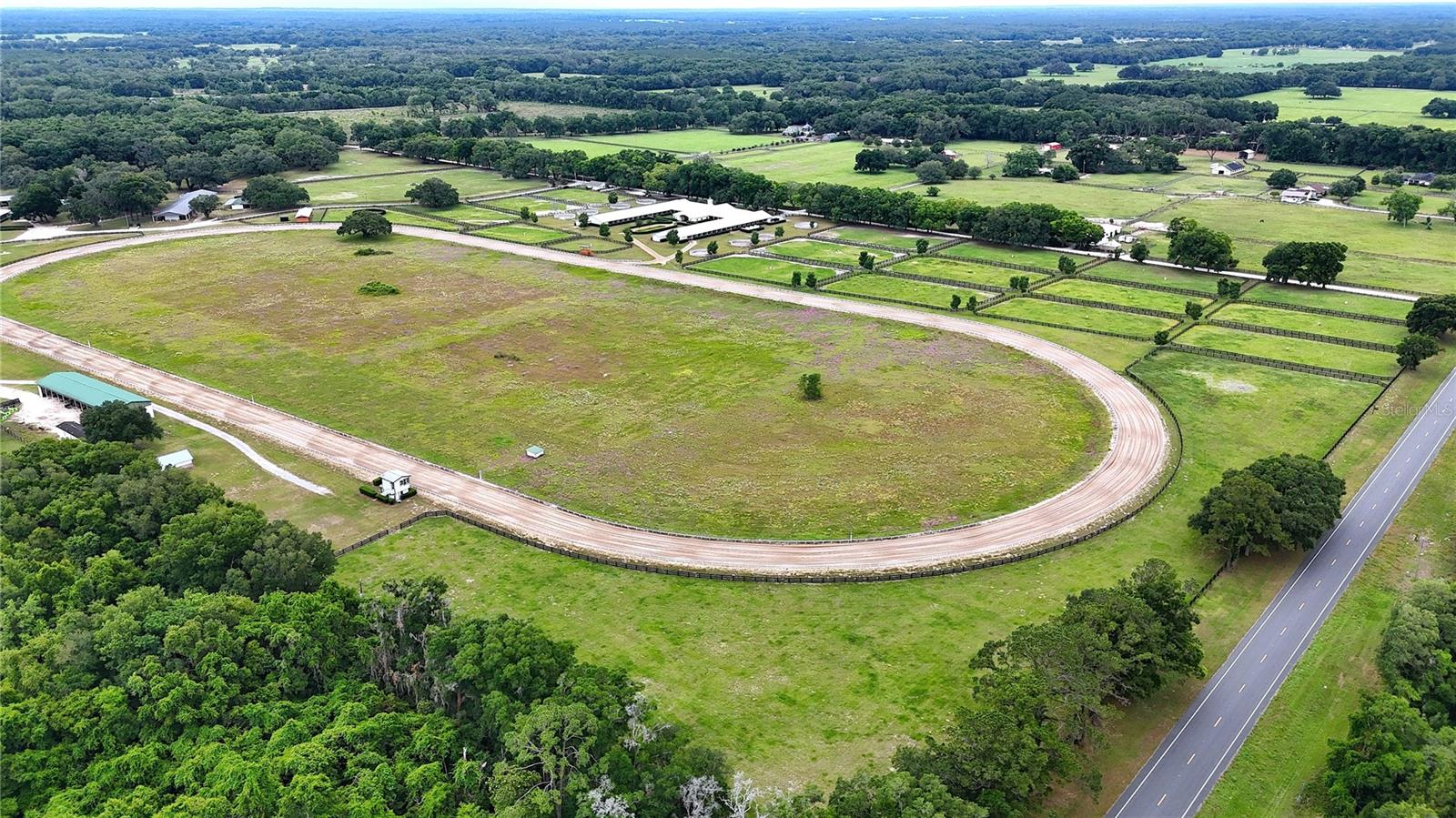 "Own 1/2 a share in a premier ¾ +/- mile race track equestrian facility, combining modern amenities with serene countryside beauty. Ideal for professional trainers, competitive riders, or equine enthusiasts, this exceptional property offers everything needed to run a successful horse training operation. Expansive Acreage: Sprawling over 47+ acres of lush, green pastures, providing ample space for riding, training, and grazing. Fully Equipped Training Facility: boasting 3 barns with 138 stalls. The main barn features 100 fully equipped stalls with excellent ventilation. A total of 8 round pens, ideal for various training exercises and starting young horses. Additionally, two sets of three wash racks provide ample space for grooming and cooling down horses. It also includes an office area for managing operations and client meetings. The second barn offers 14 stalls and an additional round pen, perfect for specialized training and boarding. Luxurious Living: A charming, fully renovated mobile home. This home's interior has been tastefully remodeled, boasting modern fixtures, new flooring, and updated appliances. The open-concept layout creates a bright and inviting atmosphere, perfect for daily living and hosting guests. Spacious wrap-around porch, offers the perfect blend of indoor and outdoor living. Additional Buildings: Tack rooms, feed storage, and a workshop, all designed to support the facility's daily operations. Conveniently located near the Williston Airport.