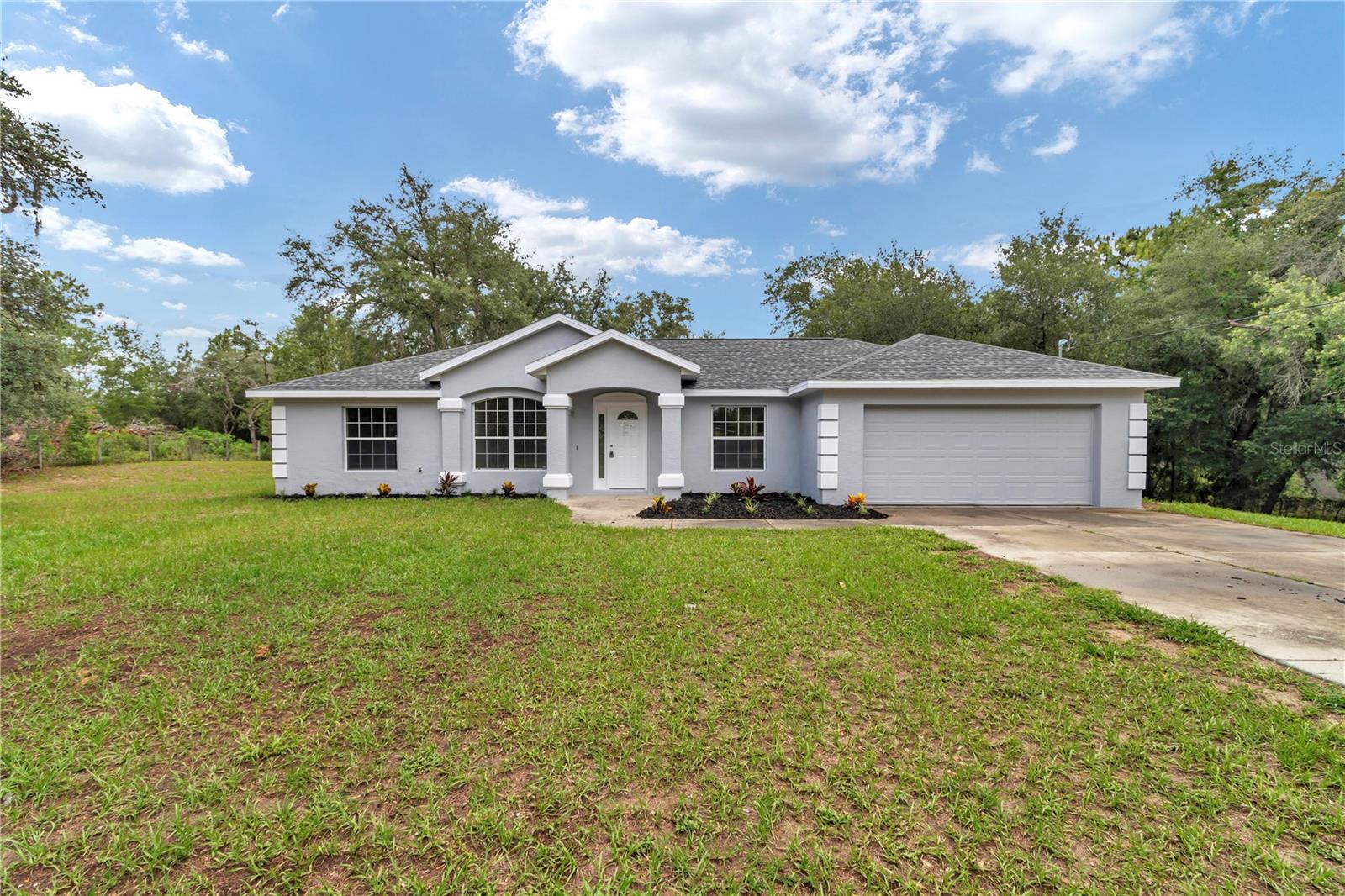 TEAR UP THE "HONEY-DO" LIST! Move-in Ready on 1.25 Acres — No HOA, No CDD - Every major update has been done for you — move in and start living. This pristine 3/2/2 sits on a fully fenced 1.25-acre lot in Morriston, one of Levy County's most sought-after rural communities with no HOA and no CDD eating into your budget. TOTAL PEACE OF MIND — Brand-new GAF Roof (2026) backed by a transferable GAF lifetime warranty — a rare and valuable asset for the next owner. NEW HVAC (2026) with manufacturer's warranty until 2036. NEW Water Heater (2026). Inside, enjoy freshly painted interiors and exteriors, stunning NEW LVP flooring, and a full suite of NEW stainless steel appliances — all on well and septic, meaning NO monthly water or sewer bills. THE LIFESTYLE: This is Levy County rural living at its finest — private, spacious, and fully updated. You are minutes from Williston Elementary, Williston Middle-High School, and Regional General Hospital Williston. Outdoor enthusiasts will love the proximity to Goethe State Forest — 53,000+ acres of hiking, biking, and equestrian trails. Easy access to US-27 for the Ocala commute. Enjoy the screened lanai, 2-car garage, and fully fenced yard — all with NO HOA and NO CDD. Schedule your private tour today — this one won't last!