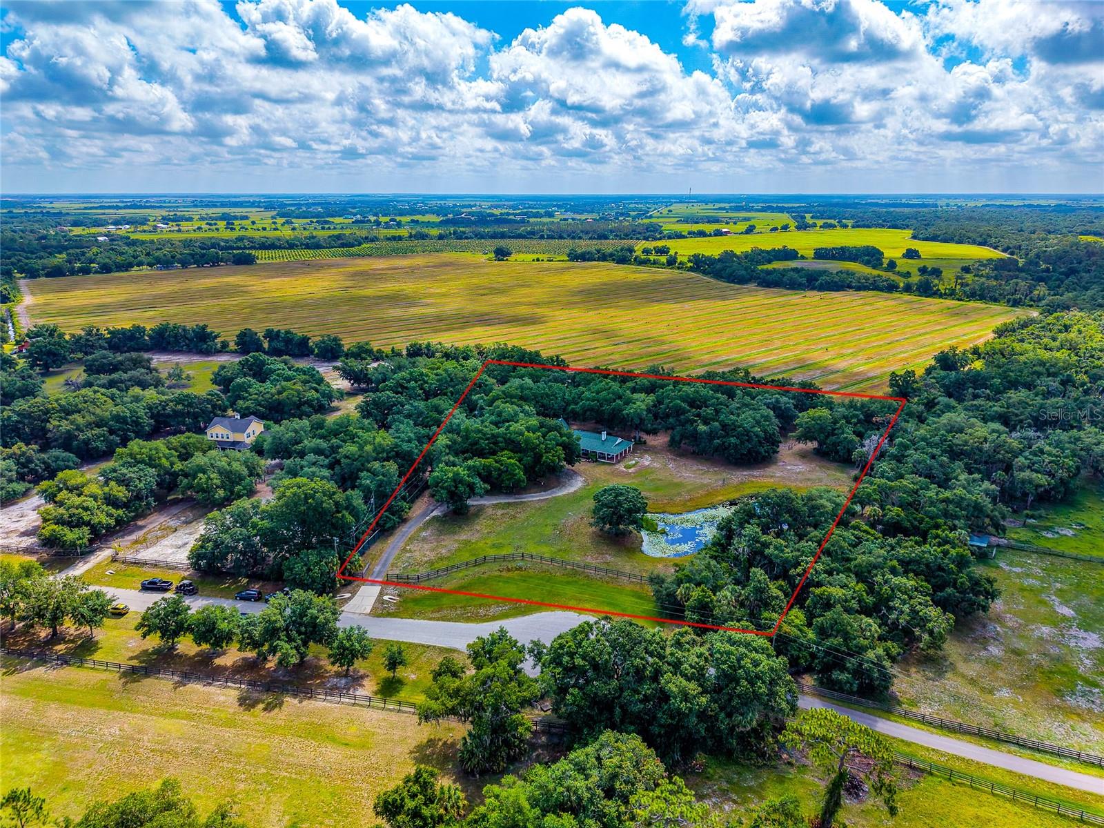 Where Privacy Is Permanent – 
A Rare 5.18-Acre Estate in Myakka City. Some properties simply cannot be recreated. Welcome to one of Myakka City's most private estate properties, where 5.18 beautiful acres meet permanently protected conservation land, creating a setting that offers peace, privacy, and natural beauty that is increasingly rare in Southwest Florida. Nestled at the end of a quiet cul de sac, this beautifully maintained concrete block home is surrounded by majestic oak trees, abundant wildlife, and hundreds of acres of protected conservation land, ensuring the breathtaking views and unmatched privacy will remain for generations to come. Adding to the property's unique character is a natural, flowing creek along the southern boundary that feeds into Mossy Island Slough. A private clearing with a picnic table has been thoughtfully created along the creek, offering a peaceful retreat where you can relax beneath the trees, enjoy your morning coffee, read a book, or simply listen to the gentle sounds of flowing water. It's a hidden sanctuary that makes this property unlike any other. Inside, the home offers comfortable living spaces filled with natural light and picturesque views of the surrounding landscape. Whether you're entertaining family and friends or enjoying a quiet evening on the porch, every window reminds you that you've found a truly special place. Recent improvements include a new roof (2022), new water heater (2025), and generator-ready wiring, providing confidence and peace of mind for years to come. Beyond the home itself, there is room to create the lifestyle you've always imagined horses, gardens, a workshop, recreational vehicles, or simply wide-open space to enjoy. The combination of usable acreage, mature trees, a peaceful creek, protected conservation land, and an end of the road location creates a property that is exceptionally difficult to duplicate. Located just a short drive from Lakewood Ranch, Sarasota, and Gulf Coast beaches, you'll enjoy the convenience of nearby amenities while coming home to the quiet beauty of Old Florida. This is more than a home, it's a place to reconnect with nature, enjoy lasting privacy, and create memories for years to come. Opportunities to own a property with this combination of natural beauty, protected surroundings, and thoughtful improvements are truly rare.