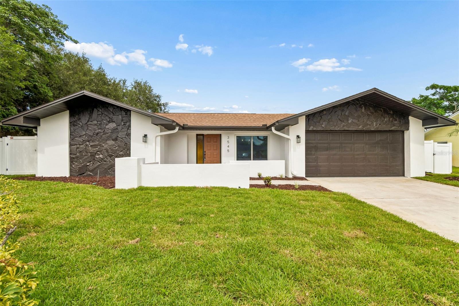 Virtually Staged. Welcome home to this fully renovated, turn-key oasis in Palm Harbor that blends modern luxury with relaxed Florida living. Tucked away on a quiet cul-de-sac, this 3-bed, 3-bath pool home is completely move-in ready. Step inside the bright, open floor plan featuring fresh interior paint and seamless transitions. The showstopping chef's kitchen boasts premium quartz countertops, all-new stainless steel appliances, a massive center island, and a stylish dry bar with a built-in wine fridge. Both the open living spaces and beautifully updated bathrooms showcase meticulous attention to detail. Large glass sliders lead to an expansive screened lanai, new vinyl privacy fence and private pool, perfect for entertaining. With fresh exterior paint, NO HOA fees, and a secure NON-flood zone designation, this property offers ultimate peace of mind. Located moments from the world-renowned Innisbrook Golf Course, this gem won't last long. Book your showing today!