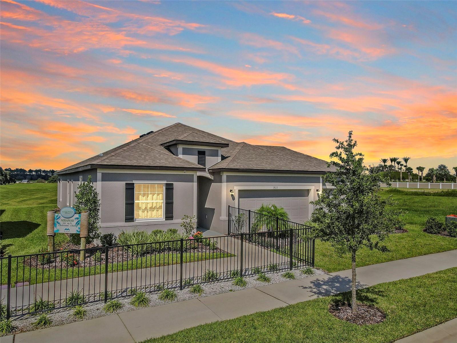 Welcome to 11822 June Briar Loop at the Mirada Lagoon Community. The Lagoon is open! This stunning 4-bedroom, 2-bathroom MODEL HOME built by Maronda Homes is move-in ready! As you enter the home, you'll be greeted by a spacious, bright living area seamlessly flowing into the dining and kitchen areas. The kitchen features granite countertops, stainless steel appliances, and ample cabinet space for all your storage needs. The master suite is a true oasis, boasting a large bedroom with plenty of natural light, a walk-in closet, and an ensuite bathroom with dual sinks, a garden tub, and a separate walk-in shower. Three additional bedrooms provide plenty of space for guests, and a second bathroom with a tub/shower combo provides added convenience. This 2,161-square-foot home also features quartz countertops, grey shaker-style cabinets, laminate flooring, a two-car garage, and a covered lanai, perfect for enjoying the beautiful Florida weather. Don't miss your chance to make this stunning model home your own! The home is currently being used as a model home, and the leaseback is in place for 7+ months. The tenant's rent is $3,458 per month. This lovely home is in the exclusive Mirada Lagoon Community. Rent includes cable + the fastest internet in the nation, Ultra-Fi, and the Crystal Lagoon Membership.The closest Elementary Schools are Innovation Preparatory Academy, a tuition-free charter school by Metro Development Group, and Pasco Elementary School. The nearest middle school is Pasco Middle School, and the nearest high schools are Kirkland Academy of Innovation High School and Pasco HS. LIFE AT THE LAGOON is like nothing else... The Mirada Lagoon Community features “Street Leaf” (solar streetlights), and a Crystal Lagoon Community (OPENING SOON), where Residents will soon have access to Paddle Boarding, Kayaking, a Wibit Obstacle Course, Cabanas, Sandy Beaches, Live Music Events, Swim Up Bar and Resident Only Events. The Lagoon is like an Outdoor Clubhouse. The planned Holiday/Seasonal Events include Trivia Night, Family Night, Movies on the Lawn, Sounds of Summer (live music series), Karaoke, Pumpkin Patch in November, Golf Cart parades, Cinco de Mayo Resident only celebration, Fourth of July Resident Only celebration and much more. The Mirada Community Amenities include dog parks and golf cart paths. This home is about 10 minutes from KRATE (the new outdoor mall), 20 minutes from the Tampa outlets, 35 minutes north of Downtown Tampa, 45 minutes from Tampa International Airport, and an hour and a half from Orlando and Walt Disney World. Available for Tours 7 days a week.