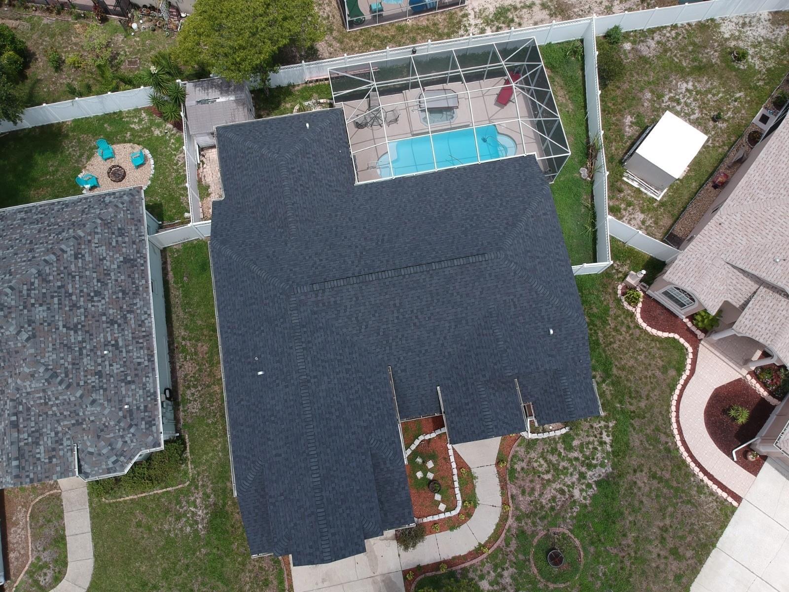 Short Sale. Tucked away on a cul-de-sac in the desirable Hunters Lake community, this spacious 4-bedroom, 3-bath pool home offers a flexible layout and inviting outdoor living. Built in 2002 and featuring a newer roof (2022), the home also includes solar panels (paid off) for added energy efficiency.

The main level welcomes you with formal living and dining areas, a den perfect for a home office or flex space, and an eat-in kitchen equipped with stainless steel appliances. Tile flooring runs throughout the home, with no carpet in the owner’s suite. The primary suite is a true retreat, featuring dual sinks, dual closets, a garden tub, and private access to the screened pool area.

An upstairs suite with a bedroom and full bath provides ideal space for guests or multigenerational living. Step outside to enjoy Florida living at its best with a screened and enclosed pool, 6 feet deep, complete with a hot tub, perfect for relaxing or entertaining year-round. The backyard also includes a convenient storage shed.

With a 2-car garage, no CDD fees, and a central Pasco County location close to shopping, dining, and major roadways, this home combines comfort, function, and lifestyle in one exceptional offering.