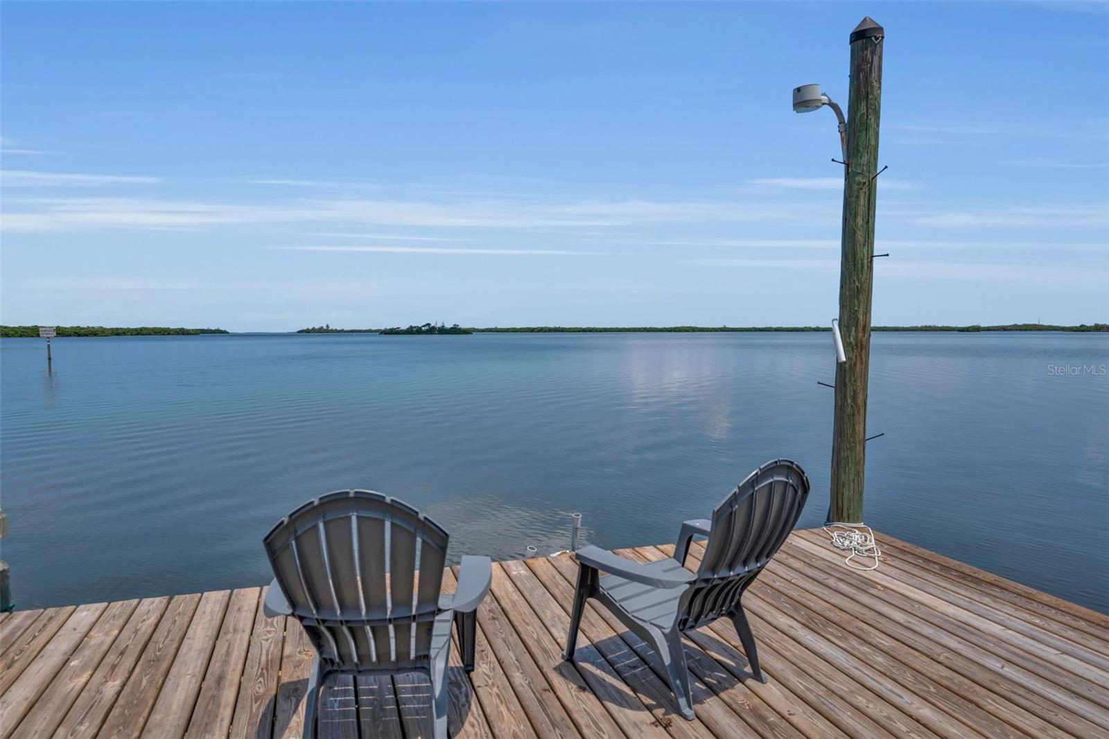 One of Terra Ceia Island's most unique waterfront estates is now available. Spanning nearly 1½ acres across two separate parcels, this remarkable property includes two residences and one of the island's most spectacular settings on Miguel Bay.
This is the Florida waterfront lifestyle dreams are made of. Morning coffee and sunset happy hours just feel different when dolphins and manatees become your neighbors. Western exposure delivers breathtaking sunsets with the iconic Sunshine Skyway Bridge as your backdrop.
With no bridges between your dock and Tampa Bay or the Gulf of Mexico, boating, waterfront restaurants, world-class fishing, Egmont Key, Passage Key, and sunset cruises are just minutes away.
Originally built in 1937 and thoughtfully updated, the main residence blends timeless character with modern comfort. The kitchen, dining room, and great room are designed to capture panoramic water views, while a beautiful coral fireplace adds warmth and authentic Old Florida charm. Whether preparing dinner, gathering around the table, or relaxing beside the fire, the water is always part of the experience.
The spacious upstairs owner's suite features a private waterfront balcony, spa-inspired bath with soaking tub and separate shower, plus flexible bonus space for an office, fitness room, nursery, or sitting area.
Outdoor living is exceptional with a newer heated pool, expansive paver deck, covered pavilion, putting green, fire pit, mature tropical landscaping, charming tabby walkways, private dock, and boat lift.
The estate also includes a beautifully updated 3-bedroom, 2-bath guest home on its own one-acre parcel, ideal for extended family, guests, caretakers, or potential rental income.
Two separate Manatee County parcel IDs provide the flexibility to preserve this family compound or potentially sell the homes separately in the future.
The first-floor living area sits approximately 14 feet above sea level and sustained no storm damage during the 2024 hurricanes. A whole-house generator, attached two-car garage, two-car carport, and abundant room for boats, RVs, trailers, and recreational equipment complete the property.
With no deed restrictions, you'll enjoy the freedom to park your boat, RV, trailers, and recreational vehicles.
As an added bonus, owners may join the Terra Ceia Village Improvement Association for approximately $250 a year, providing access to a private waterfront park with a boat ramp, fishing pier, pavilion, grills, pickleball courts, and community events.
This is more than a waterfront home—it's a private waterfront family compound where friends and family can fish from the dock, spend the afternoon in the pool, boat to lunch, and end the day watching another unforgettable sunset over Miguel Bay.

Every day feels like a vacation, and the best memories are made without ever leaving home.

Must be purchased with the adjoining guest residence located at 1057 Bayshore Road, Terra Ceia (MLS #A4697049). Convenient to St. Petersburg, Tampa, Bradenton, and Sarasota.
