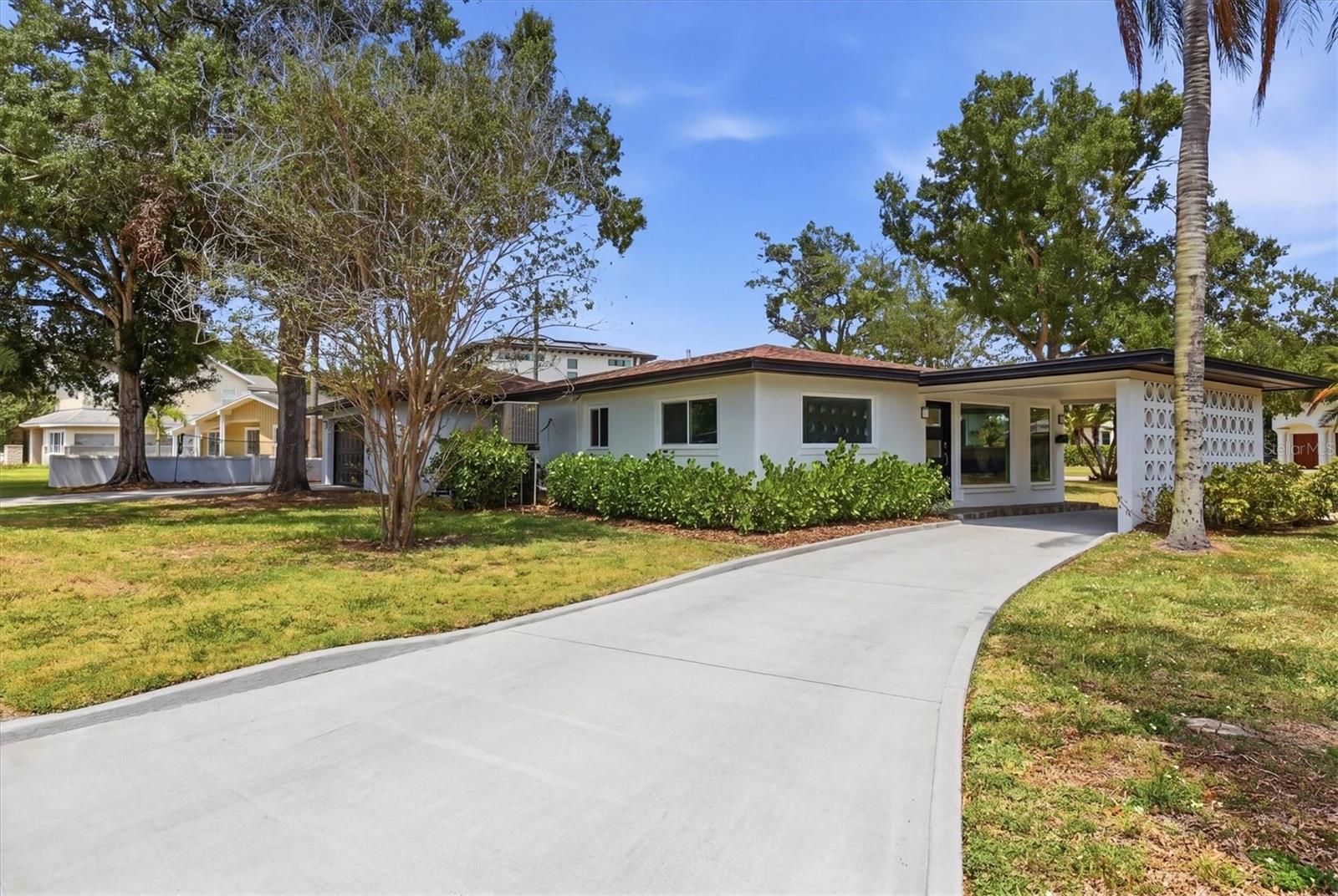Live the Davis Islands life with this fully renovated single-story home on an expansive 10,900 sq ft corner lot. Offering 4 bedrooms, 3 baths, a dedicated office/den, 2-car garage, and over 2,400 sq ft of thoughtfully designed living space. The open floor plan flows effortlessly, making the most of every square foot. Large picture windows anchor the family room at the front of the home, bathing the space in natural light. This room connects with the more formal dining area as well as a private office/den off the main living area, perfect for working from home or a playroom. An additional separate living room overlooks the large screened-in porch and backyard, creating a great space for entertaining or relaxing. The kitchen has been completely redesigned with quartz countertops, plenty of wood cabinetry in a two-tone palette of blue lowers and white uppers, new stainless steel appliances, and a peninsula for casual dining. A dedicated coffee bar with wine fridge and additional storage adds a great finishing touch. The split-bedroom layout places two bedrooms on each side of the home, offering added privacy. The primary suite features built-in closets while the primary bath boasts a dual vessel vanity, glass-enclosed walk-in shower, and modern tile finish. The two additional bathrooms have been enhanced with updated vanities, one featuring a walk-in shower and the other a tub/shower combination. All bedrooms are generously sized, offering comfortable space for family or guests. Additional updates include new LVP flooring throughout, new central A/C (2025) plus new mini-split (2025), new water heater (2025), updated electrical, hurricane impact windows, and artificial turf in the rear yard. Located on picturesque Davis Islands, this home offers an unparalleled lifestyle in a vibrant, walkable community favored by professional athletes, executives, and families alike. The neighborhood is home to a wealth of amenities, including Marjory Park Marina, the Sandra Freedman Tennis Complex, the historic Roy Jenkins pool, and Peter O. Knight Airport. A short stroll brings you to the Davis Islands Village, where you'll find a variety of restaurants and shops. With its prime location just minutes from Downtown Tampa, Water Street, Sparkman Wharf, and the Tampa Riverwalk, this home truly offers the best of both island living and urban convenience. Additionally, it is situated within the boundaries of the highly rated Gorrie Elementary, Wilson Middle School, and Plant High School.