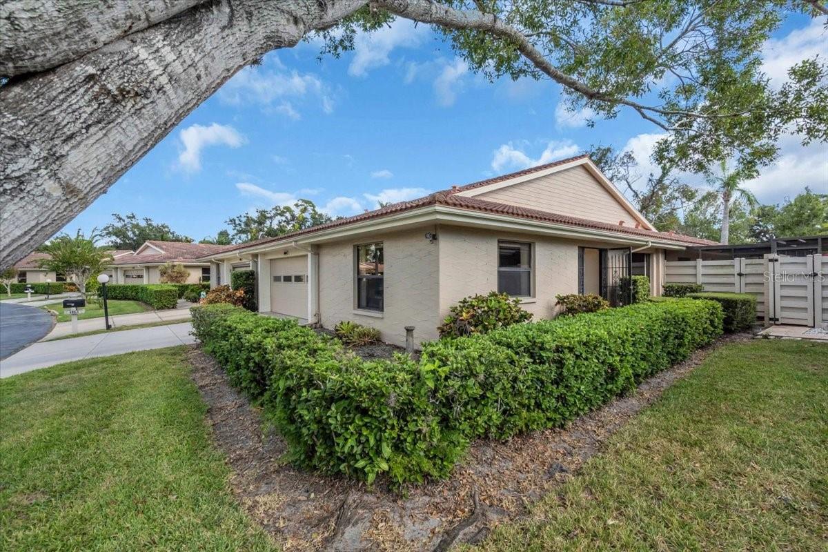 One or more photo(s) has been virtually staged. PRICED TO IMPROVED TO SELL! Where can you find a large home with approximately 2000+ sq ft under air for under $310K in Sarasota? Right here! Discover a rare opportunity to own a spacious and distinctive 3-bedroom, 2-bath villa in the highly desirable Center Gate Villages 5, a charming and well-established 55+ community in the heart of Sarasota. Villas of this size are seldom available in this neighborhood, making this an exceptional find for buyers seeking space, character, and a prime location.

With soaring ceilings and a warm, welcoming ambiance, this home offers the flexibility to embrace its unique motif or transform it into your own personalized retreat. A generous foyer sets the tone, with a guest bedroom to the left featuring custom built-in shelving—ideal for a home office, den, or hobby room. To the right, a versatile living space can easily serve as a dining room, family room, or additional entertaining area.

The open-concept kitchen and living room are designed for both comfort and entertaining, featuring quartz countertops, fresh paint, updated lighting, a water filtration system, and a striking stone-faced wood-burning fireplace beneath cathedral ceilings and a skylight that fills the space with natural light.

Enjoy the best of Florida living with two lanais. Sliding doors lead to an enclosed, screened Florida room upgraded with accordion shutters and glass sliders for seamless indoor-outdoor flow. A second lanai runs alongside two bedrooms and offers direct slider access from each, complete with a canopy overhead—perfect for soaking up the sunshine. 

Relax with morning coffee on the long side patio or in the Florida room overlooking a peaceful nature preserve backdrop, privacy all around.

All bedrooms are generously sized with ample closet space, including a serene primary suite retreat. Additional highlights include a spacious interior laundry room with a new washer, a 2-car garage with extensive cabinetry, and a large safe, providing exceptional storage throughout. Recent updates include HVAC (2018), water heater (2018), refrigerator (2018), range (2016), washer (2024), and an updated primary bathroom shower.

Located just steps from the community pool and minutes from shopping, dining, hospitals, I-75, UTC Mall, golf courses, and Sarasota’s world-famous beaches, this home offers a maintenance-free lifestyle with all the benefits of Sarasota living.

Priced to sell—schedule your private showing today and experience the charm and possibilities for yourself.