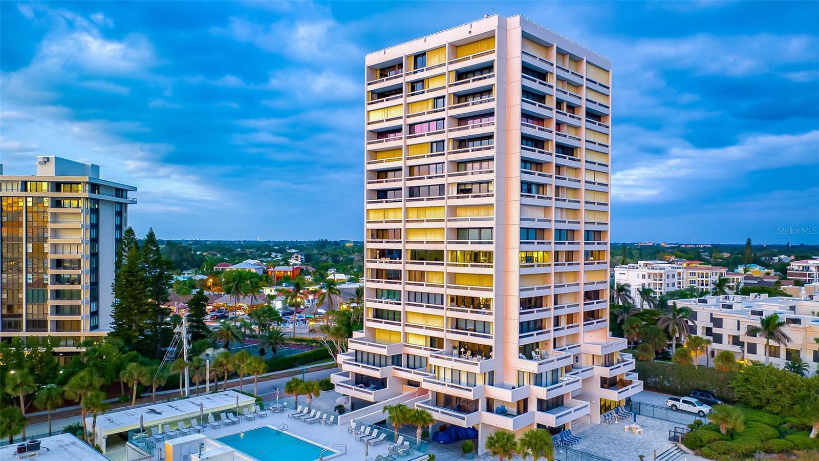 Rarely does an opportunity like this emerge on Siesta Key — priced below the last comparable 1-bedroom sale and reduced over $120,000, this is value that simply cannot be ignored.  Welcome to Beach Terrace, one of Siesta Key's most sought-after Gulf-front addresses. Nestled at the end of the village in a gated community with direct Gulf frontage, this exceptional corner residence delivers the quintessential Siesta Key lifestyle — world-famous white quartz sand at your feet, the sparkling aqua Gulf stretching to the horizon, and the energy of Siesta Key Village just a short stroll away.  The panoramic views here are genuinely extraordinary. From the pristine beach below to the glittering skylines of downtown Sarasota and Longboat Key in the distance, every glance outward is a postcard moment. At night, the twinkling lights of the village and city skyline transform the backdrop into something truly magical — widely regarded as one of the finest views on Siesta Key.  Three private balconies ensure there is always a perfect perch for morning coffee, evening sunsets, or simply savoring the coastal scenery throughout the day. Inside, dual sliding glass doors flood the living area with natural light while framing those sweeping Gulf views. The tiled foyer flows seamlessly into a well-appointed kitchen, and the dining area offers ample space to entertain with a backdrop that will leave guests speechless.  Resort-style amenities complete the picture: an elevated heated saltwater pool, community room, and the security of a gated community — all just steps from your private beach access. This is Siesta Key living at its finest — Gulf-front, gated, walkable, and priced to sell.