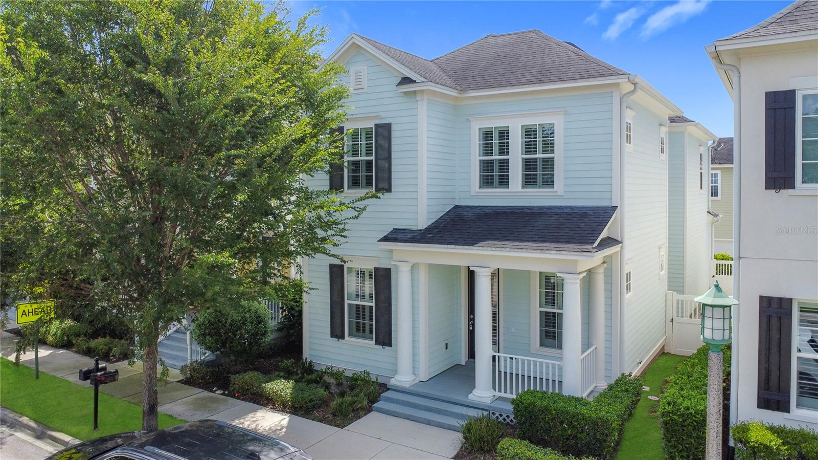 Welcome to this amazing, coastal-style home located in CELEBRATION! three-bedrooms and two and one half bathrooms, greeting you with a graceful front porch highlighted by architectural columns. Upon entry, you step into an open floor plan with thoughtful details throughout. The kitchen features 42” cabinets, granite countertops, a stainless steel built-in oven, microwave, cooktop with stainless steel vent hood, bright tile back splash, upgraded lighting. There is seating space around the large kitchen island, with the dining room conveniently located right off of the kitchen. An ingenious closet finished with an organization system acts as a drop zone, with a half bathroom also located on the first floor. The second floor has a versatile loft space that can be used as a sitting room, a play area, an office, etc. The laundry room has custom built cabinets around the washer and dryer for storage, along with a folding area. The spacious primary suite has a tray ceiling, crown molding and ceiling fan. The primary bathroom has a soaking tub, separate shower and dual sinks with gorgeous quartz counters. The primary closet has a full California closet system installed and even has a window letting in natural light. The second and third bedrooms each have private access to a shared bathroom. All carpets are brand new, and there are plantation shutters throughout the home. The two-car garage features a tall ceiling, storage space, and a Tesla Car Charger. In addition to all this, the Spring Park amenity area features a swimming pool, fitness center and gathering space only a block away!