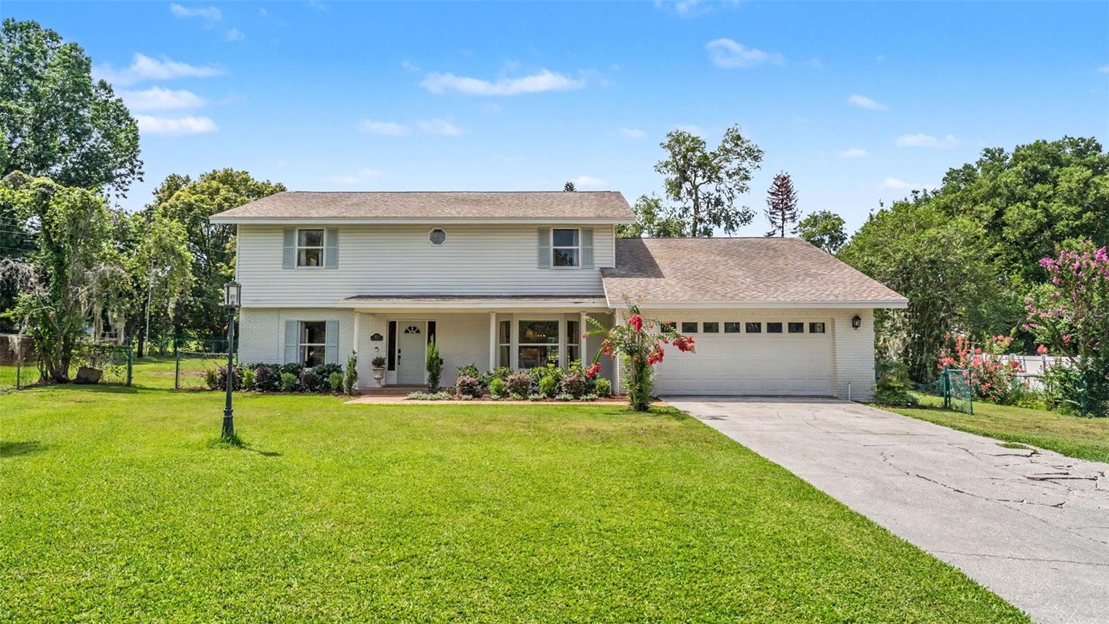 A place you can call home for years to come! This charming South Lakeland POOL home offers space, the freedom of NO HOA and a wonderful location. A crisp painted brick exterior with nice landscaping offers a welcoming first impression. Upon entering the home, you will make note of the tasteful recent updates throughout, including stylish fixtures, attractive wood-look luxury vinyl flooring, and a gorgeous, remodeled kitchen. A large dining room provides a perfect space for formal meals, while the kitchen island offers additional seating for easy entertaining and casual daily living. The dream kitchen includes beautiful cabinetry with lighting to highlight the tiled backsplash, stainless steel appliances, a closet pantry, and a view of the pool from your kitchen sink. Vaulted ceilings, wooded beams and a brick, wood-burning fireplace are create a warm and inviting atmosphere in the family room. French doors lead out to the pool with screen enclosure and separate spa. Situated on a .49 acre fully fenced lot with a playset, here you have plenty of room for outdoor play and recreation. Downstairs, there are two attached rooms that can serve as bedrooms (one does not have a closet, but one can be added), or flexible spaces to suit your needs for an office, play area, hobby room, or more! Upstairs there is a spacious primary suite with a huge bedroom, walk-in closet, and en-suite bathroom with a shower, water closet and dual sinks. Two additional bedrooms are located upstairs, one of which is particularly large with an extended walk-in closet. There’s also an updated hallway guest bathroom for convenience. Ample storage is offered throughout, with great closets, an interior laundry room, and an air conditioned workshop/closet attached to the 2-car garage. With excellent nearby schools and convenient access to the Polk Parkway, this home has a sought-after location, paired with a flexible floor plan with room to grow, making it a sound long-term investment.