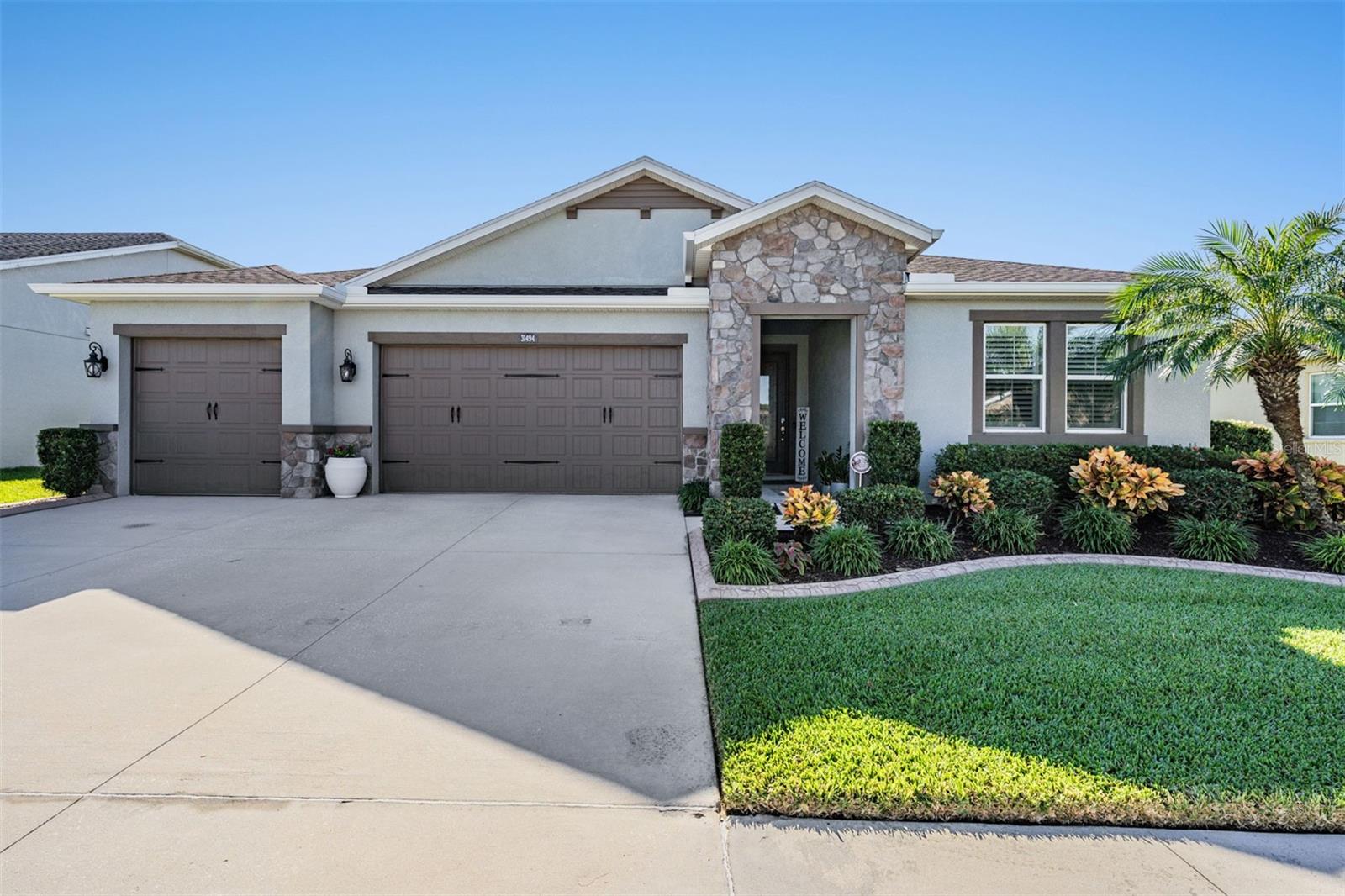 Honey stop the car! This stunning and open concept floorplan is just what you have been waiting for! Located in the GATED and highly sought after community of the Enclave in Meadow Pointe IV. Featuring 3 bedrooms, 2 baths, with an OVERSIZED laundry/office/craft room, & 2.5 car garage. Overflowing with TONS of upgrades including a GOURMET kitchen with built in oven and cooktop, QUARTZ & Granite counters, glass tile backsplash, PLANTATION shutters throughout the home, 8-foot doors, and a fully fenced yard. As you enter, you're greeted with an expansive foyer with luxury LAMINATE flooring throughout the main areas of the home. Off to one side are two well-appointed bedrooms and a full bathroom. The beautiful kitchen opens up to the living and dining rooms, with the owner's suite situated nicely off to the rear of the home. The owners ensuite highlights dual sinks, a walk-in shower, and two walk-in closets! The laundry room is oversized with the washer and dryer included, built in wash sink, and plenty of cabinets for storage. Enjoy the beautiful Florida weather year-round on the OVERSIZED lanai highlighting IMPACT windows and the NEW privacy shades give for a cozy and private feel. The lanai has beautiful stamped concrete, added electrical, and easy access to the fenced backyard. The garage is oversized which is ideal for a gym, workshop, or to store your toys or golf cart. Meadow Pointe IV offers a clubhouse with a beautiful pool area, fitness center, basketball court, volleyball & tennis courts, park, playground, and peaceful walking trails. Located in the heart of Wesley Chapel close to Wiregrass Mall, two major hospitals, Tampa Premium Outlets, top rated schools, Advent Health Center Ice rink, WCAA District Park and the best dining, shopping, and entertainment Wesley Chapel has to offer. Easy access to SR-56 and I-75 makes your commute a breeze. Schedule your showing today!