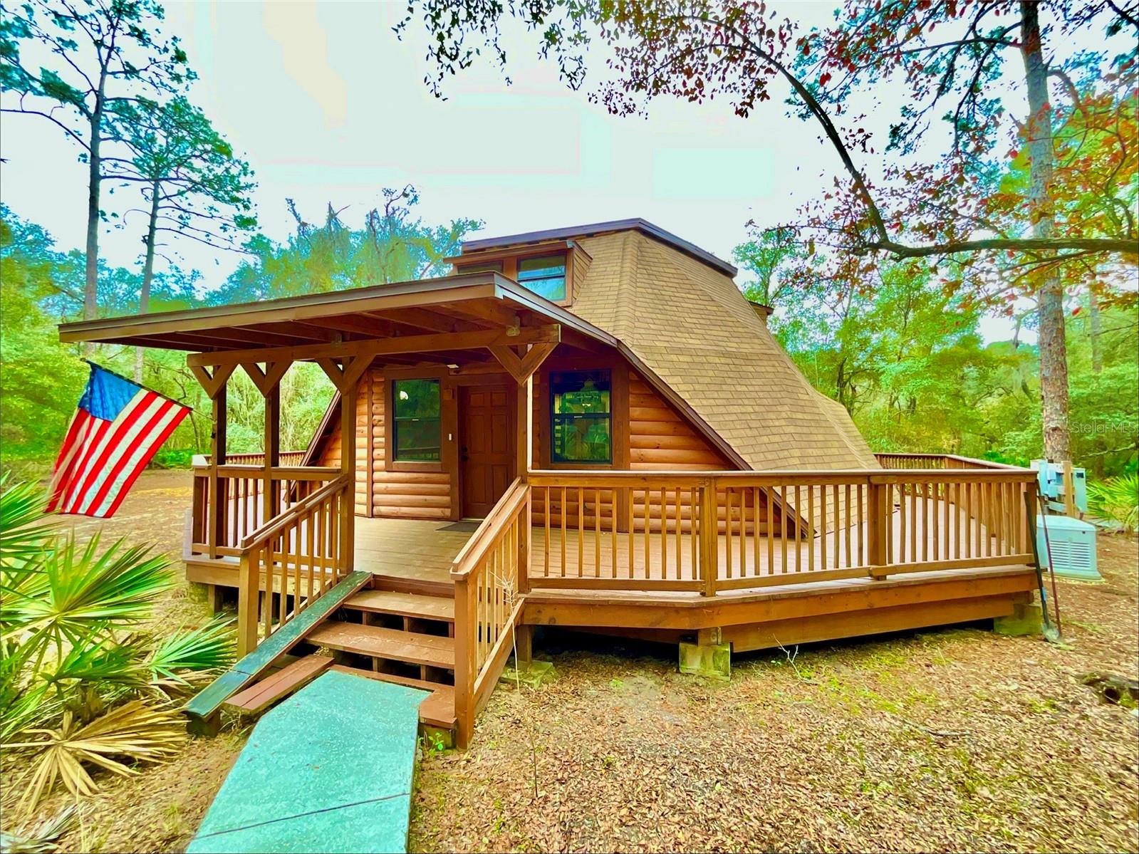 Discover a truly unique architectural home on 6.75 acres with serene pond frontage in Melrose. This custom dome-style residence features soaring ceilings, open-concept living, and a dramatic spiral staircase to a loft-style primary suite overlooking the main living area. Distinctive design creates an airy, light-filled interior with rare character. Additional bedrooms on the main level offer flexible living space. Detached garage/workshop for storage or hobbies. Updates include newer HVAC, new hot water heater, and whole-house generator. Enjoy privacy, natural surroundings, and room for recreation or gardening. Convenient to Melrose, Keystone Heights, and commuting distance to Gainesville. Ideal for buyers seeking a distinctive retreat, artist’s haven, or private homestead with nature views and unmatched architectural character. A rare opportunity to own a truly iconic dome home in North Florida. Schedule a private tour today. Don’t miss this architectural gem!