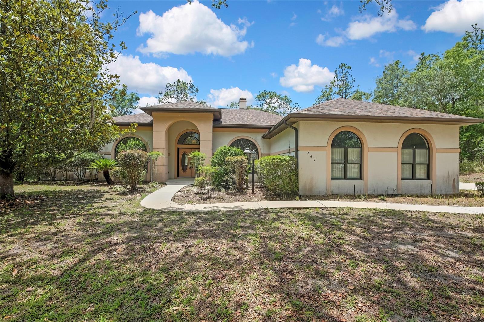 Beautiful sprawling Florida style home with split bedroom plan, house is one one landscaped treed acre and  sitting on the middle of 3 acres, 1 acre on each side that is  separately deeded should a buyer want to sell the lots on either side, vaulted open ceilings, propane fireplace between living and family rooms, open style pool home with huge open and shaded concrete deck area with outdoor kitchen area, wooded lot with mature landscaping, lots of tile flooring throughout, side entry garage door.  Privacy is offered in abundance with this one owner home, lots of closets too.  Heated chlorine  pool is great for swimming year round and heats up quickly  and also has a hot tub attached.  Primary bedroom has garden tub and large shower and double walk in closets, with sliders off the primary bedroom, living and family rooms as well.  Two full and two half baths, one off the pool area. Storage building in the yard for additional storage.
ZILLOW lists this home as a HEATED SALT POOL,  I have reached out to ZILLOW and they won't change it!!! It is a HEATED CLORINE POOL.  This home is sold AS IS but inspections welcome.