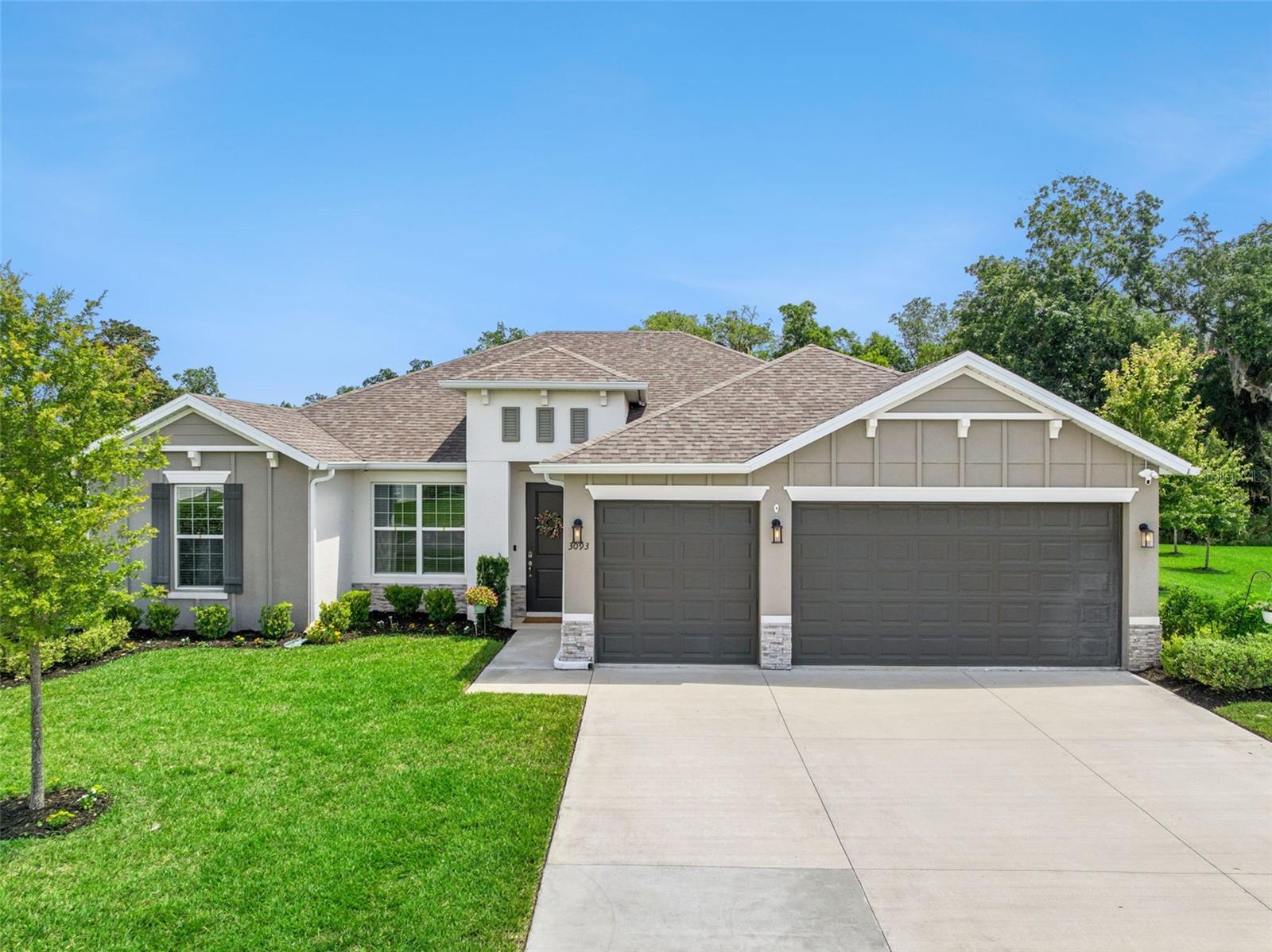 Luxury Estate Pool Home in Halifax Plantation Golf Community – A Private Waterfront Retreat - Welcome to an exceptional luxury residence located in the highly desirable golf community of Halifax Plantation in historic Ormond Beach, Florida. Built in 2023 and perfectly positioned on an expansive 0.37-acre homesite overlooking a tranquil pond with a beautiful illuminated fountain, this better-than-new estate home offers the perfect combination of elegance, comfort, and Florida resort-style living.  Featuring 4 spacious bedrooms, 3 full bathrooms, a flexible bonus room, and an oversized 3-car garage, this thoughtfully designed open-concept floor plan is enhanced with premium upgrades and custom features throughout.  The heart of the home is a spectacular gourmet kitchen designed for both everyday living and entertaining, featuring stainless steel appliances, upgraded lighting, abundant cabinetry, two pantry closets—including a generous walk-in pantry—and a seamless flow into the spacious great room. The living area is anchored by a stunning 84-inch linear electric fireplace, creating a sophisticated focal point and inviting gathering space.  The luxurious primary suite serves as a private retreat, complete with a custom built-in wall unit, an expansive walk-in closet professionally outfitted with a premium closet organization system, and a spa-inspired ensuite bathroom designed for relaxation.  Bedroom 3 offers its own private ensuite full bathroom, creating the ideal space for overnight guests, visiting family members, or a multigenerational living arrangement where privacy and comfort are appreciated.  Step outside to your own private resort. The enormous 1,300-square-foot screened paver lanai showcases a sparkling 14’ x 28’ inground saltwater swimming pool and offers multiple areas for outdoor dining, entertaining, and enjoying Florida’s year-round sunshine. Beyond the lanai, the peaceful pond setting creates a picturesque backdrop, where evenings often bring visits from local deer as the sun sets—a truly magical daily experience.  The fully equipped 3-car garage adds exceptional functionality with ceiling-mounted storage systems and a utility sink, providing ample room for vehicles, tools, hobbies, and recreational equipment.  Located within Halifax Plantation, residents enjoy a picturesque setting of mature oaks, scenic landscapes, championship golf, and a relaxed coastal lifestyle just minutes from beaches, shopping, dining, and the historic charm of downtown Ormond Beach.  This is more than just a home — it is a lifestyle. A rare opportunity to own a nearly new, meticulously upgraded waterfront estate where luxury, nature, and tranquility come together in one unforgettable setting.