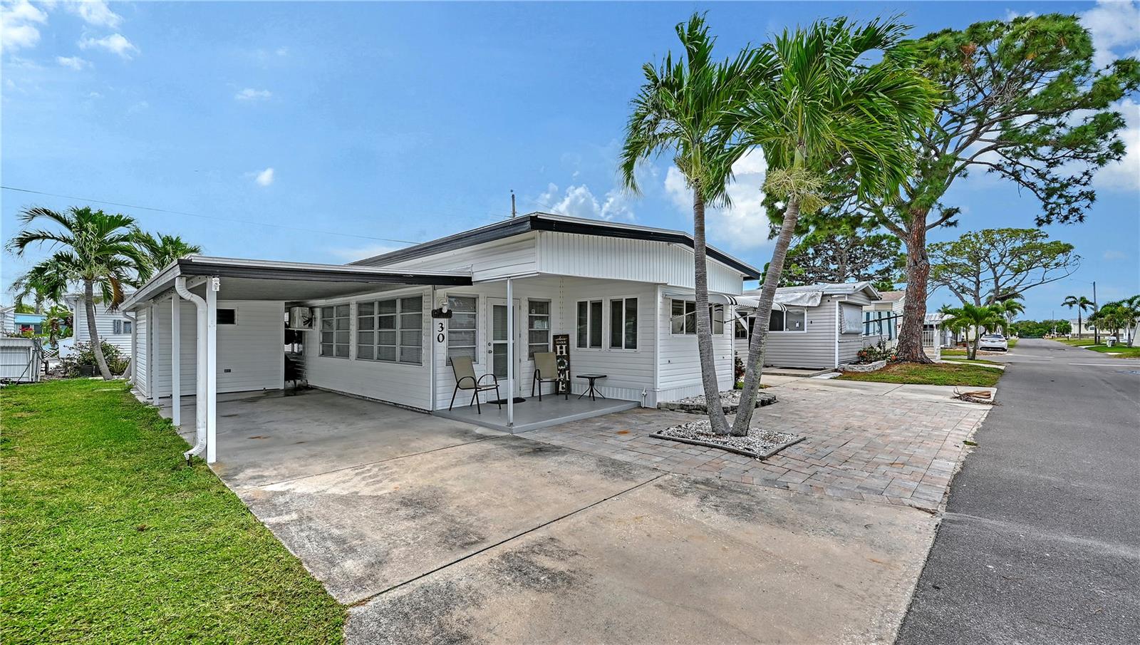 Look no further! You have come upon a very well-appointed home in the 55+ community of Paradise Bay. A boaters, outdoor enthusiasts & community friendly lifestyle is waiting for you! This "beachy vibe", turnkey home is tastefully furnished, remarkably clean, updated & one of the best values for everything that is included. Enter from your covered front porch into a generous size living room/family room with a comfy sofa bed, extra seating & a wall mounted flat screen t-v for relaxing gatherings. One step up brings you into a large eat in kitchen/dining area with seating for 6 or more. In addition the breakfast bar which conveniently overlooks the living room to join in the conversation can accommodate up to 4 barstools. Your "L" shaped kitchen has an abundance of storage, plenty of natural light, full size refrigerator & even a dishwasher. The bathroom has a walk-in shower with newer glass sliding doors, very well appointed along with a linen closet. You have a king size bed in the primary bedroom with ample room to walk around & dual closets. A "bay" type alcove currently stores a "hide a bed" for all the company that will be visiting you. This would also be a perfect spot for a dresser to be tucked out of the way. The guest bedroom is one step down which a queen bed & full-size dresser fit perfectly. This room also has a rear exit to the backyard seating area. Outside here, you have your private full-size laundry/water heater room. There is also a custom-made shed with a workshop with a jealousy window for ventilation. Plenty of space to store all your holiday decor & watersports necessities. Between the shed & home is kayak storage. Discretely hidden out of the way. Paradise Bay, as the locals know, is one of the favorite parks with close proximity to the beaches of Anna Maria Island. Great history here dating back to the Ringling Circus, who once occupied this popular park community, where the workers & performers had their winter quarters. There's more than just the history of this area that makes it so appealing. Sunsets like no other, just at the end of your street. A popular spot for the community to gather on their golf carts, swing in one of the covered gazebos or enjoy one of the park benches for a front row seat at the majestic Sarasota Bay. Make sure you keep your eye on the water as well, you may spot some dolphins & manatees swimming through. You'll see & hear an abundance of birds, may want to grab your binoculars! Boat ramps are for those residing in the park only. Boat slips are available to rent & there is also a storage area for those not wanting to keep their vessel in the water. Jet skis & kayaks are also a fun way to enjoy the bay. You are so close to everything, you'll feel like every day is a vacation day. Golf courses, shopping, fast food to 5 Star Restaurants, theater, comedy, museums, Mote Aquarium, Selby Gardens, 3 airports in under 45 minutes, Cruise Ports galore, So much to see & do. The serenity of this area is soothing to the senses & make it an ideal place to call home.
New roof & 3 new zoned air conditioners. Also a dehumidifier which vents to outside. Perfect to turn a/c off when you are away for longer periods & it pulls moisture out of the air. Your home will always smell fresh even if it is closed for prolonged periods. Ingenious!