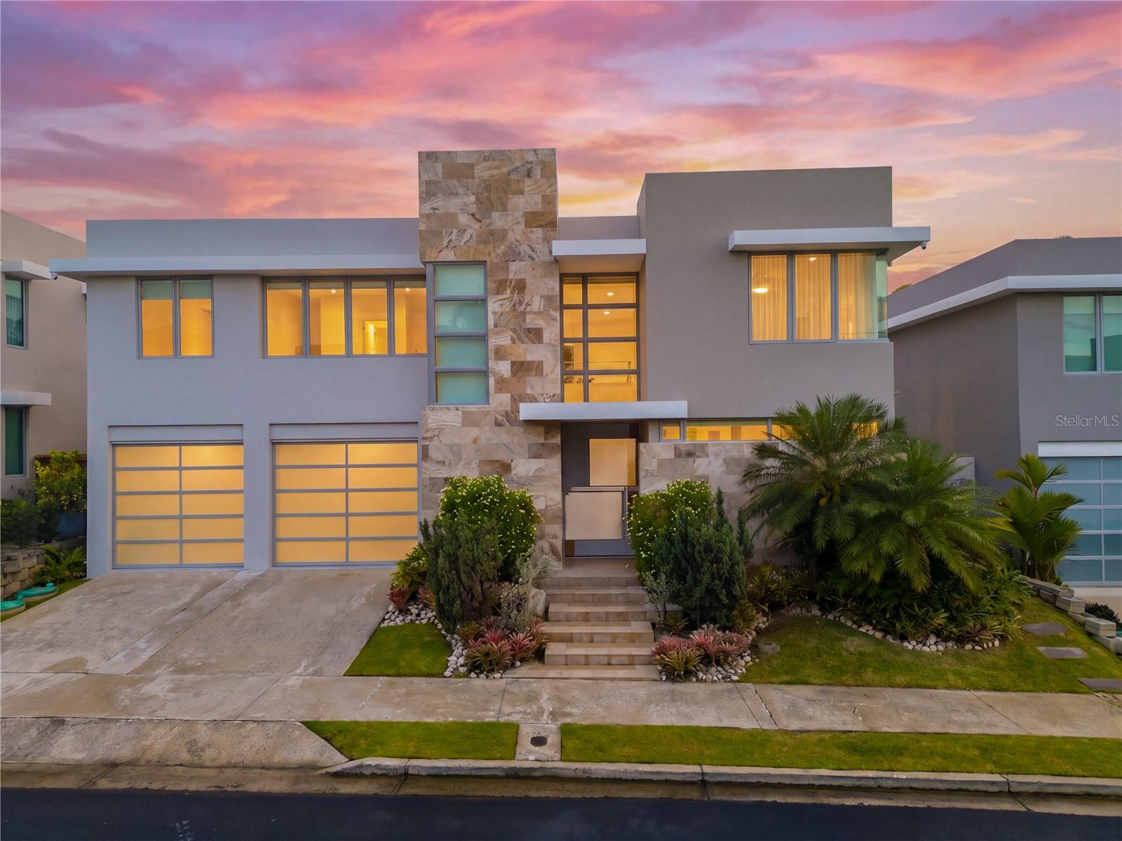 Completely remodeled two-story residence located in the private, double-gated community of Senderos de Montehiedra, San Juan. This modern home has been extensively updated and features fully paid-off solar panels, SONNEN battery backup system, full power generator, electric vehicle charging stations, water cistern, and solar water heater.

The property showcases a striking façade, lush landscaping, oversized stainless steel pivot door, and a bright open-concept layout with living, dining, and family areas filled with natural light. The kitchen, bathrooms, laundry room, appliances, A/C units, curtains, and multiple interior finishes have been renovated and updated. The home has also been recently painted and carefully maintained throughout.

Features include 4 spacious bedrooms, 3.5 bathrooms, private gym, covered terrace, 2-car garage plus additional driveway parking, and stainless steel kitchen appliances. A unique interior hatch provides convenient rooftop access.

Located within Montehiedra West, a double-gated community with 24-hour security and patrol. Residents enjoy access to Las Gaviotas Casa Club, pools, tennis and basketball courts, parks, and more. Prime location near top schools, shopping, restaurants, and major highways.

Shown by appointment to qualified buyers.