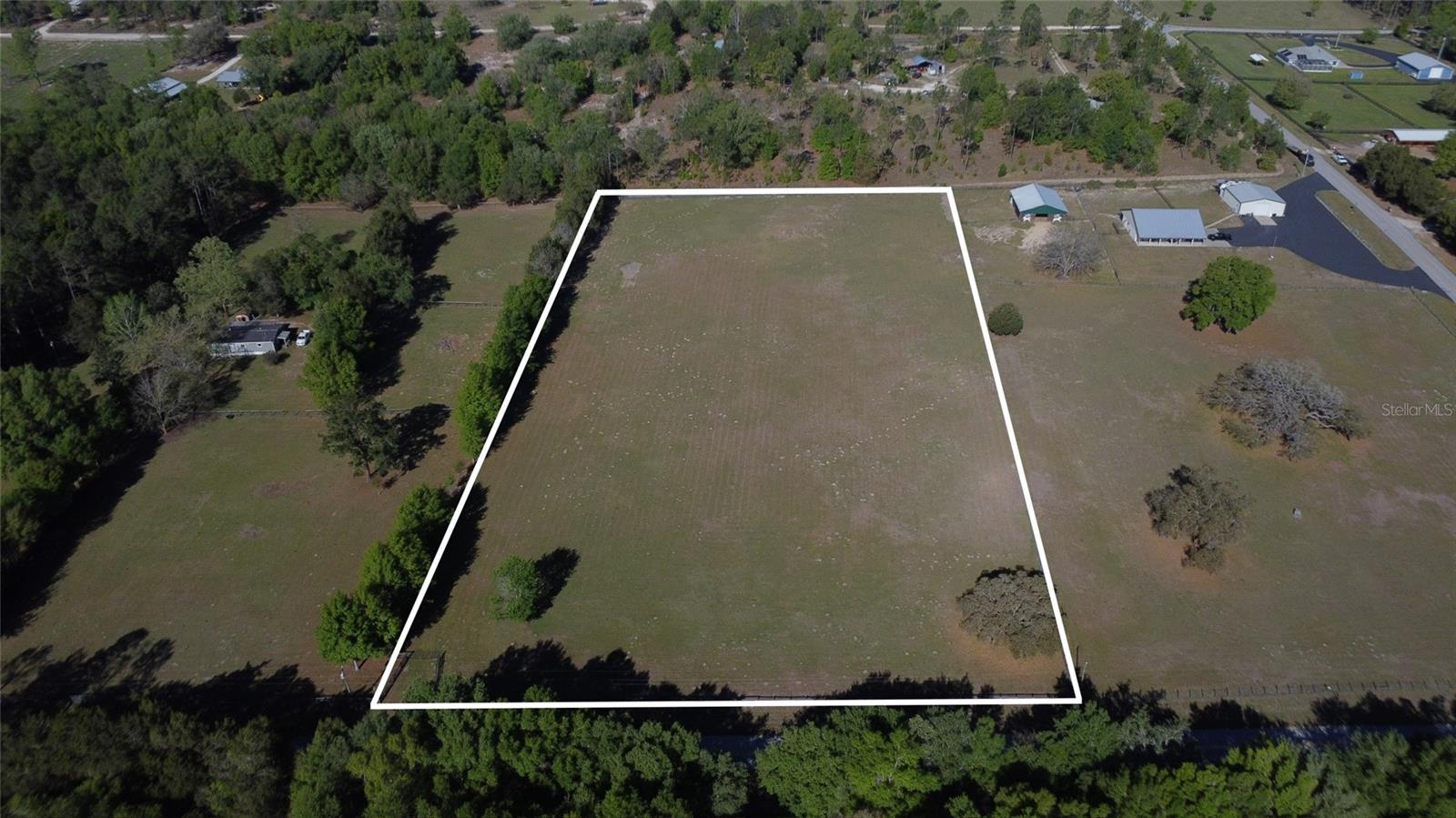BUILD YOUR DREAM HOMESTEAD ON ALMOST 5 BEAUTIFUL ACRES!
Looking for space, freedom, and flexibility? This 4.97-acre parcel on a paved road offers the ideal setting for your Florida country lifestyle. The property is already fenced with no-climb wire and three-board fencing, making it perfect for horses, livestock, hobby farming, or a private rural retreat. A healthy stand of grass is established, saving time and expense as you prepare to build.
With NO HOA and NO deed restrictions, you have the freedom to create the property you’ve been envisioning. Site-built and manufactured homes are allowed, offering flexibility whether you're planning a custom home, mini farm, equestrian property, or peaceful getaway.
Enjoy the charm of quiet country living with the convenience of paved road access, making daily travel easy while still providing privacy and space to spread out. Opportunities like this are becoming harder to find — nearly 5 acres of usable, fenced land ready for your plans.