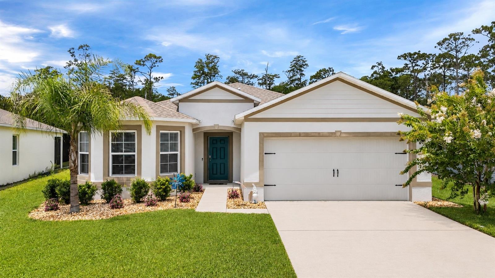 This 2022-built home in Coastal Woods delivers the rare combination of brand-new construction and an established, quiet neighborhood feel, all just 15 minutes from the beaches of New Smyrna. Inside, an open layout connects the kitchen, great room, and dining area, with durable luxury vinyl flooring carrying through the main living spaces for easy upkeep. Step out to the covered lanai for morning coffee or evening unwinding, with a backyard that gives you room to entertain, garden, or just enjoy some space of your own.
The primary suite is tucked at the back of the home for privacy, with two additional bedrooms on the opposite side, a layout that works well for families, guests, or a home office setup. A two-car garage rounds out the practical side of the home.
Coastal Woods offers that ideal in-between: close enough to New Smyrna Beach to enjoy it whenever you want, far enough to skip the crowds and come home to a peaceful street. Move-in ready and priced to reflect true market value, schedule your showing today.