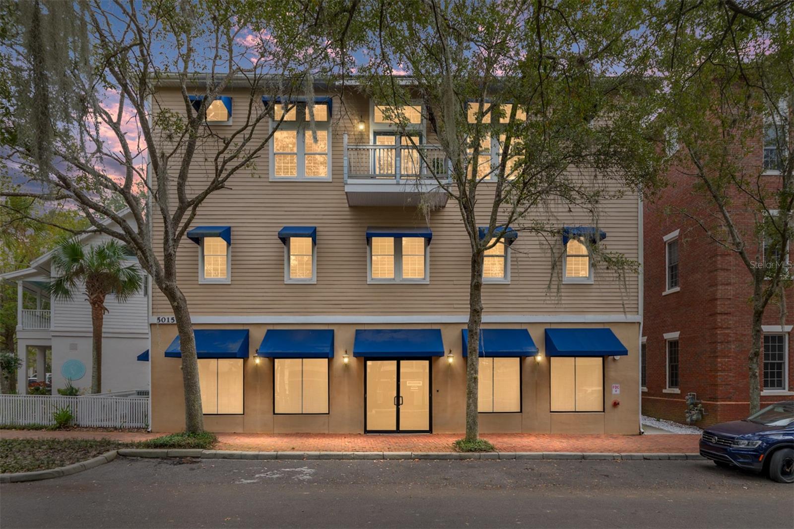 A unique opportunity awaits you in the Haile Village Center. This custom-built, three-story, mixed-use building includes an income-producing commercial space on the first floor. A private elevator provides access to your two-story, 3,700+ square foot luxury penthouse home. The third floor features luxurious finishes throughout, including wood floors, crown molding, and 15-foot ceilings. The showstopping kitchen boasts cherry cabinets, granite counters, two islands, and a Thermador appliance package. The living room/dining room combination includes a gas fireplace. This level also features a full bathroom and a theater room complete with a wet bar and refrigerator. Multiple covered balconies allow for enjoyment of the tranquil Village views and include a private summer kitchen for alfresco dining and grilling. The second floor is a quiet oasis with three full bedrooms, a study, and a gathering area. The large primary bedroom features a spacious walk-in closet and a bathroom with marble floors, a large bathtub, and a walk-in shower. The large gathering space has built-ins, a microwave, and a second wet bar area. Abundant windows provide private views of the tree-lined Village street. This premier, one-of-a-kind property is within a short distance to the restaurants, shops, and the weekly farmers market in Haile Village. The long-term tenant occupying the first floor provides rental income each month. Don’t let this unique opportunity pass you by!