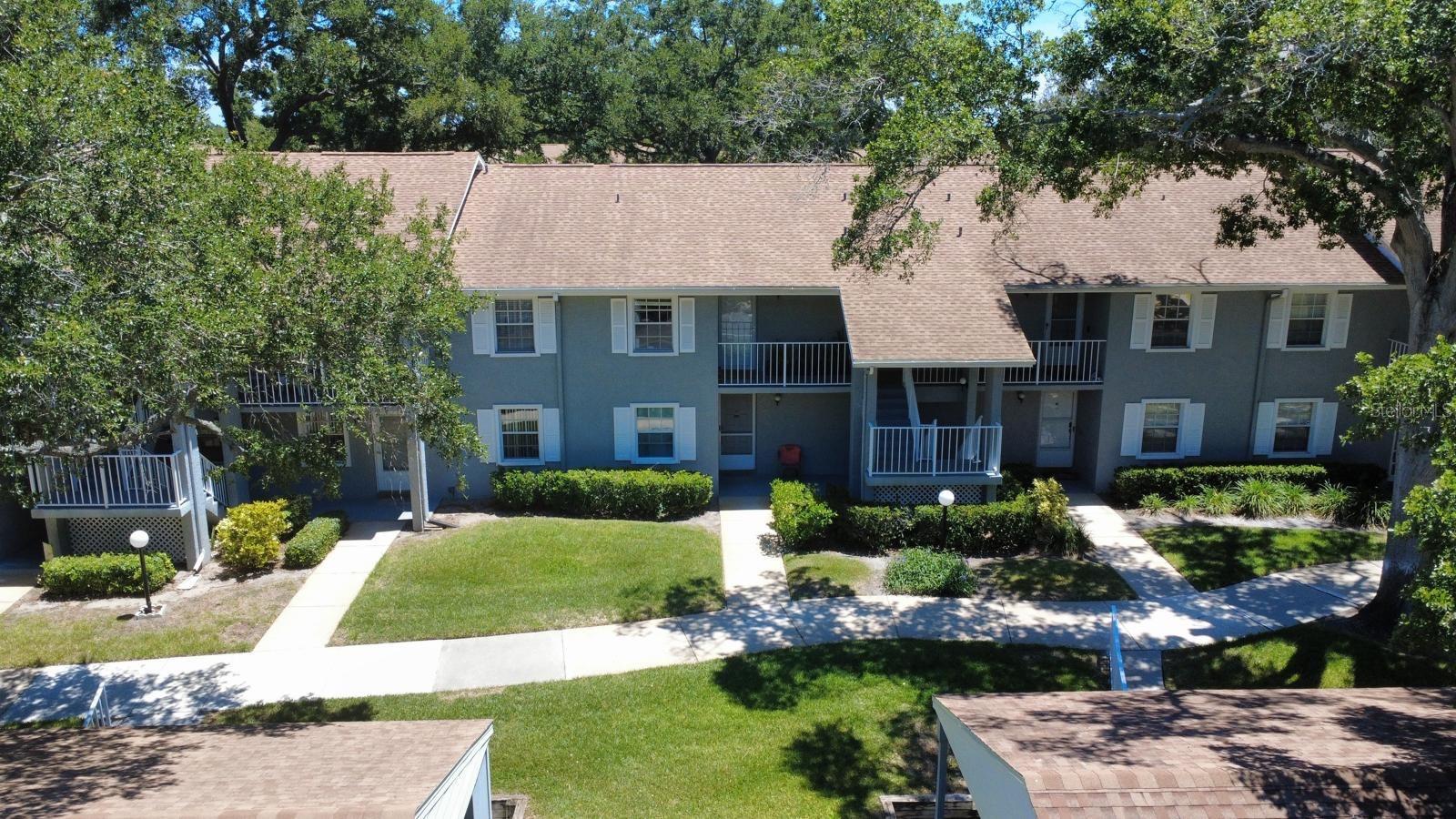 Welcome to this beautifully updated 2-bedroom, 2-bath condo located in the highly desirable Lake Tiffany community of Dunedin. This light and bright residence features a spacious open layout with vaulted ceilings, modern finishes, and durable flooring throughout. The updated kitchen offers a clean, functional design perfect for everyday living, while the split bedroom layout provides privacy and comfort.

Enjoy peaceful Florida living with a screened-in porch area ideal for morning coffee or relaxing evenings overlooking the lush, well-maintained landscaping. The unit also includes convenient in-unit laundry, generous closet space, and an assigned covered carport.

Lake Tiffany offers resort-style amenities including a sparkling community pool with cabana, beautifully maintained green spaces, walking paths, and a quiet, pet-friendly environment. The HOA provides exterior maintenance, cable/internet, and community upkeep, making ownership simple and low-stress.

Perfectly located just minutes from charming Downtown Dunedin, residents can enjoy local restaurants, boutique shops, farmers markets, and waterfront parks. Nearby attractions include Honeymoon Island State Park, Caladesi Island, the Pinellas Trail, and Clearwater Beach, offering some of the best coastal lifestyle experiences in Florida.

Whether as a primary residence, seasonal retreat, or investment opportunity, this condo delivers comfort, convenience, and an unbeatable Dunedin location.