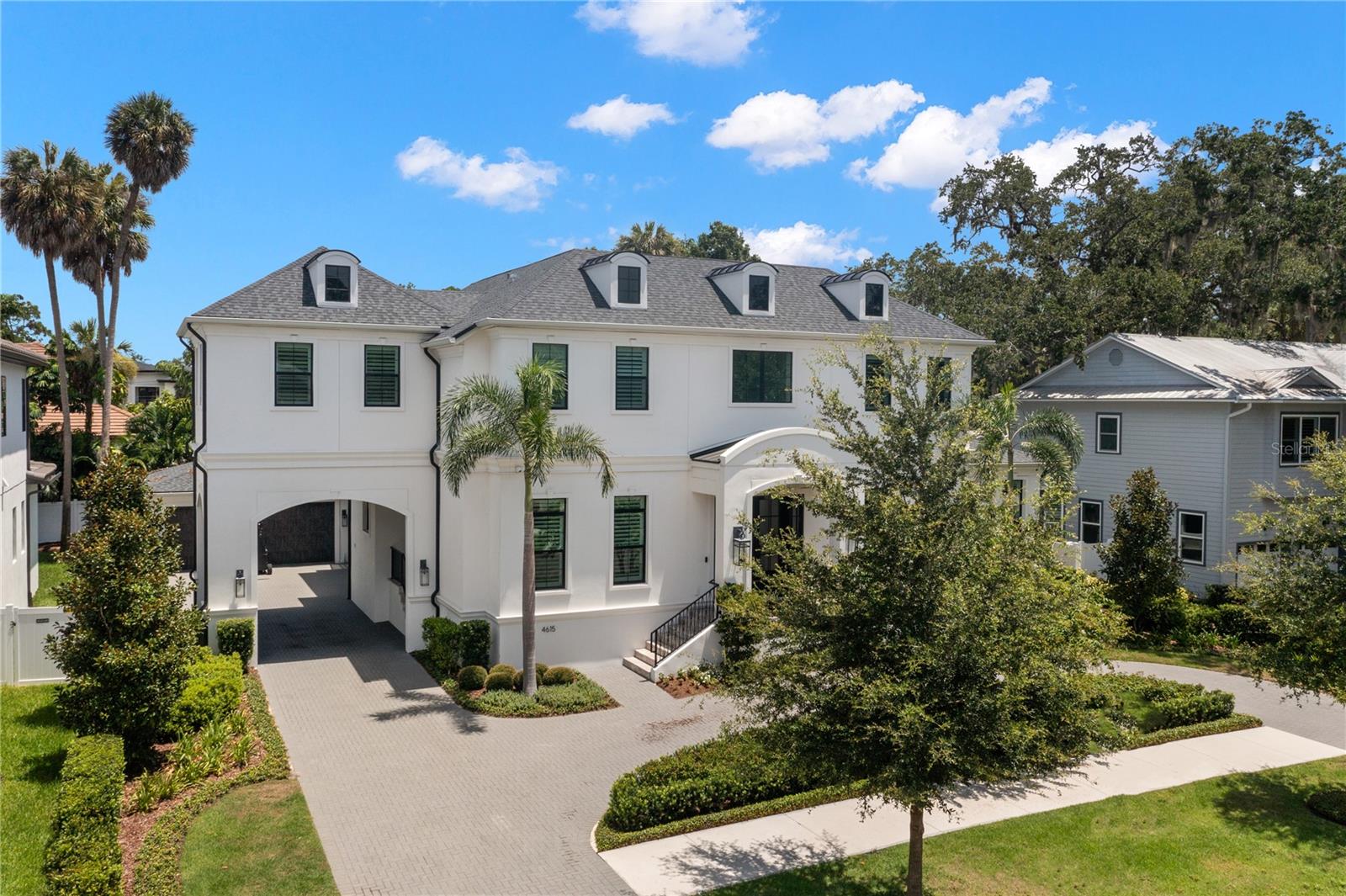 250K PRICE DROP!!! Welcome to South Tampa's Beach Park, where this stunning masterpiece built by Taralon Homes that was completed in 2021 awaits. Showcasing the elegant "Providence" model, this luxurious residence features 6 bedrooms, 5.5 baths, bonus room, heated saltwater pool with spa, outdoor kitchen with built in green egg, & so much more. Inspired by Georgian architecture, the home spans over 5,600 square feet of refined living space on a generous 95 x 128 oversized lot. The porte cochere sets the stage for the luxury within, including two primary suites—one on each floor—with ensuites, large walk-in closets, providing ultimate flexibility & convenience. The formal living/wine room impresses with a decorative rock wall & built in Sub-Zero wine storage unit. The 24 x 22 family room, with its gas fireplace, coffered ceiling, & a wall of French doors, leads to the expansive 18 x 25 foot covered lanai. Equipped with gas fireplace & Synergy Rustic Barnwood "Tavern" tongue and grove stained wood ceiling, the lanai overlooks a beautifully landscaped yard, saltwater pool/spa & outdoor kitchen, making it an entertainer's paradise. The gourmet kitchen is a chef's delight, featuring exotic quartz countertops, 48-inch gas Wolf stove with griddle & custom hood, a beautiful custom backsplash, white shaker cabinetry with soft-close, pot filler, & separate Sub-Zero refrigerator & freezer units. Custom light fixtures, crown molding, & coffered ceilings enhance the sophistication of the space. A large center island offers ample storage & room for bar stools, complemented by a large eat-in area with views of the pool & opens to the family room. The first floor also includes a versatile 12 x 15 bedroom that is currently being used as an office with a wall of closets that features shelves from floor to ceiling, powder room, mudroom with custom built-ins, large walk-in pantry & butler's pantry, one of the two primary suites with a walk-in closet, dual vanities, & a walk-in shower, formal dining room, & a beautiful foyer with a grand staircase & 9' tall iron front door, sidelights and transom in Black finish & impact glass. Upstairs, an expanded owner's retreat awaits, featuring a larger walk-in closet & a luxurious bathroom with dual vanities, a makeup vanity, large walk-in shower, & a free-standing soaking tub. A 19 x 19 media/game room, three additional bedrooms with en-suite baths, & a dedicated laundry room complete the second floor. The home is adorned with plantation shutters, 7.5" plank Naturally Aged Medallion Collection Grey Mist wood flooring throughout, surround sound, Control4 smart home automation, central vacuum system, & so much more. Additional amenities include a grand two-story entry foyer with custom molding, a side-entry porte cochere for direct access to the mudroom & kitchen, oversized 21 x 28 garage with AC & a full-house water filtration system. Energy efficient with R-20 spray foam insulation in attic, 16 SEER Trane HVAC & 2 Rannai 7.5 tankless gas water heaters. Ideally located in the heart of Beach Park, mins from TPA Airport, Downtown, top-rated schools, shopping, medical facilities, & fine dining. Located just minutes away you can catch a Tampa Bay Lightning game or a concert at Amalie Arena. Raymond James Stadium to see the Bucs is only a short drive away & the Straz Center for the Performing Arts is also nearby. Experience the best of Tampa's entertainment scene right at your doorstep. Call today for your private tour!